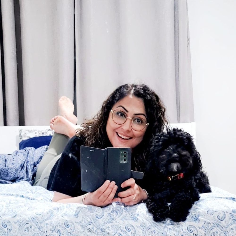 A woman with black poodle 