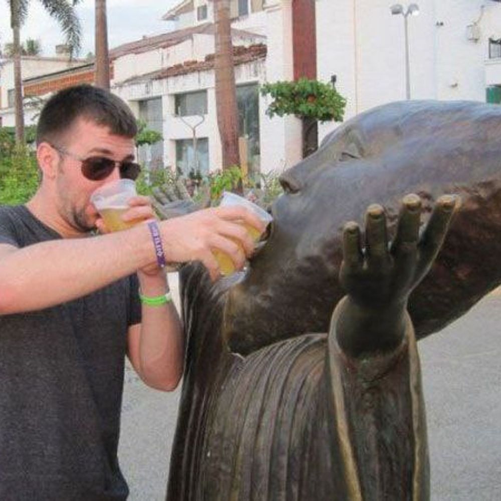 People doing fun with statues