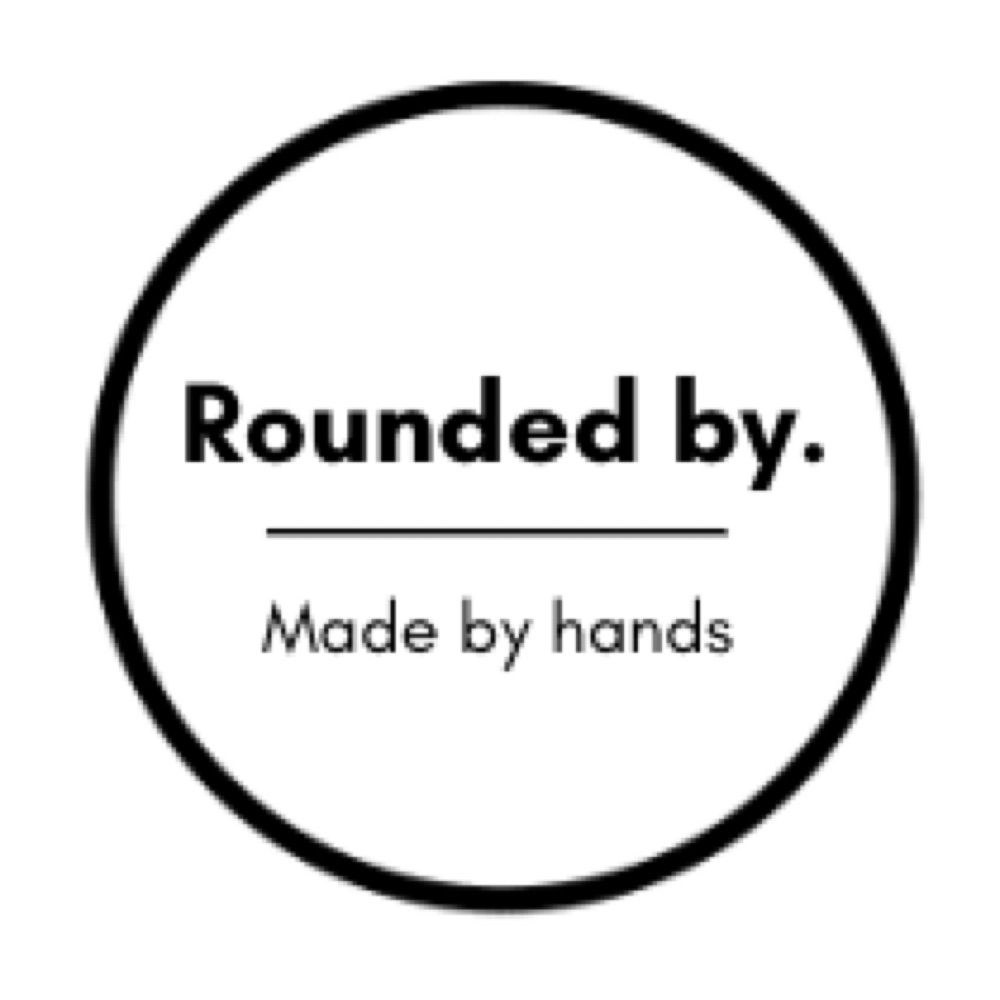 Rounded by.
