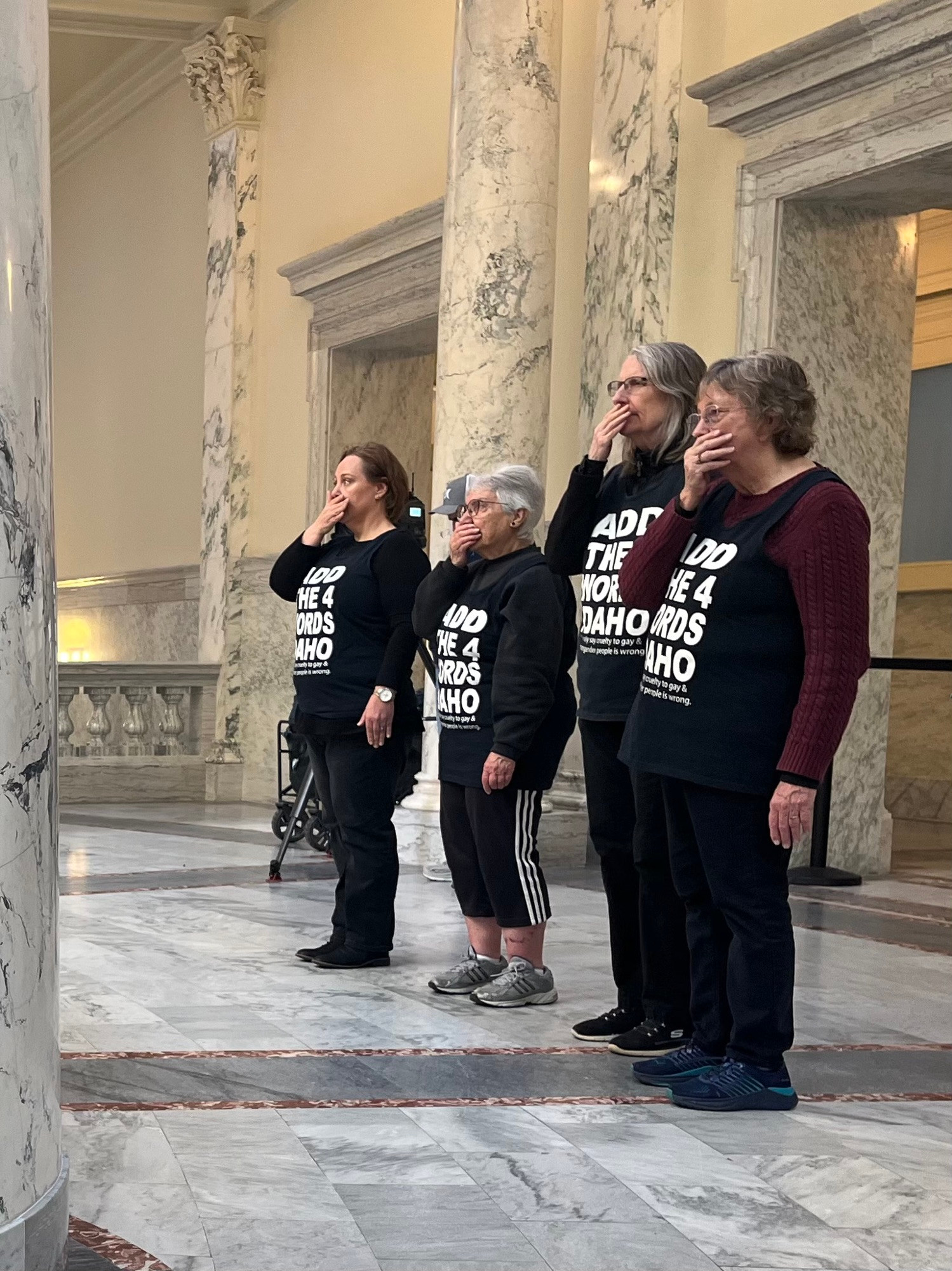 Some of the original demonstrators stand silently and respectfully with hand over mouth, a protocol stretching back 10 years. 