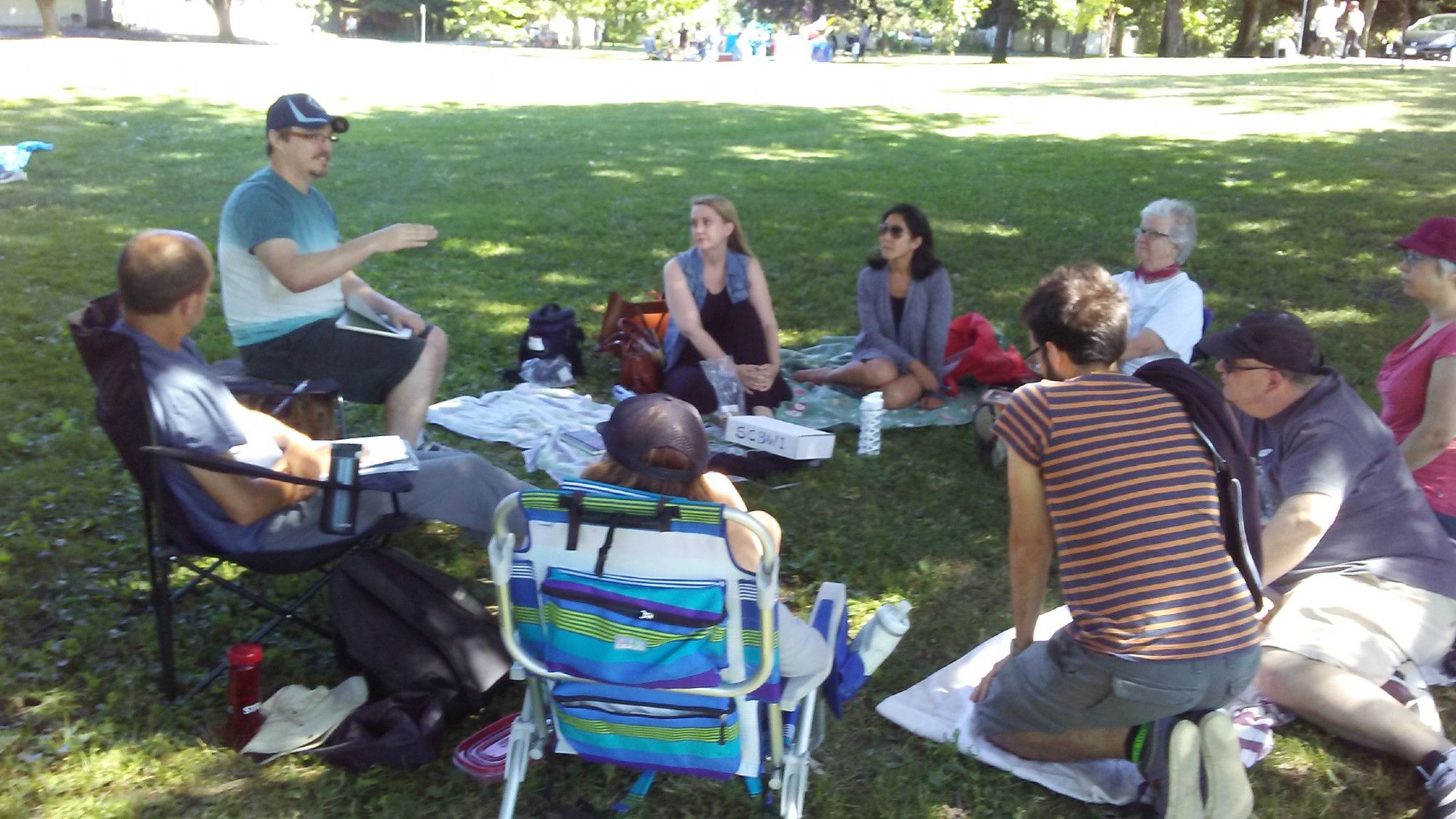 SCBWI members gathered outside at a summer critique session in park