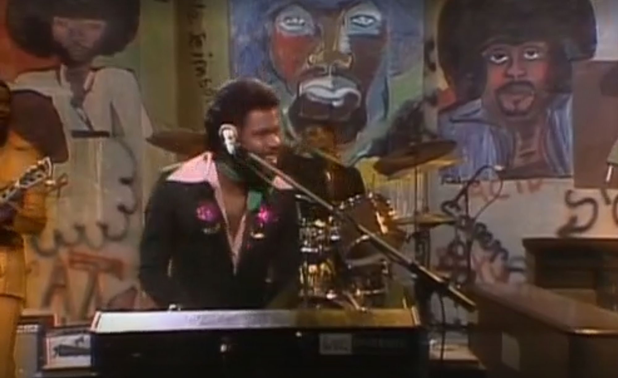 Billy Preston in a v-neck jumpsuit with giant pink collars playing the ever-loving shit out of a keyboard while performing Something from Nothing on Saturday Night Live in 1975
