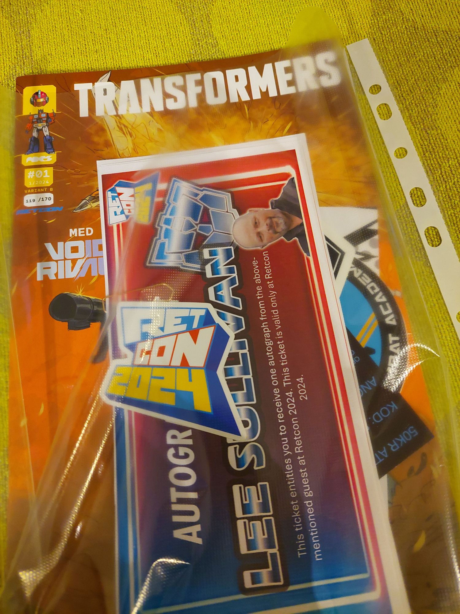 Transformers related items such as stickers, autographs tickets and comic.