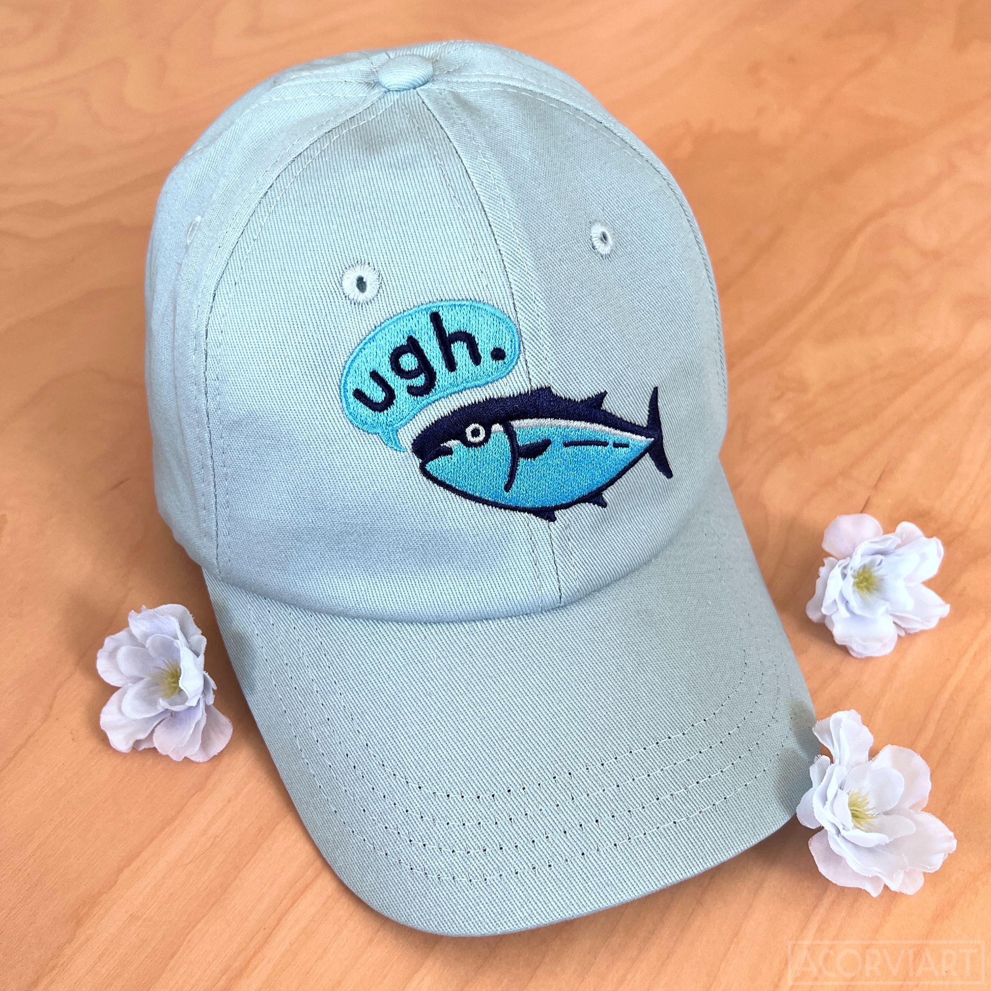 photo of a dad hat with an embroidered tuna saying "ugh"