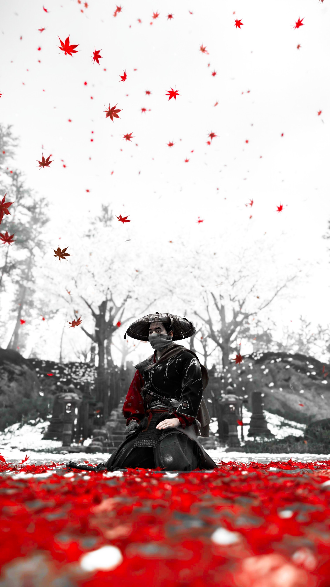 Jin Sakai from Ghost of Tsushima kneeling in amongst red leaves