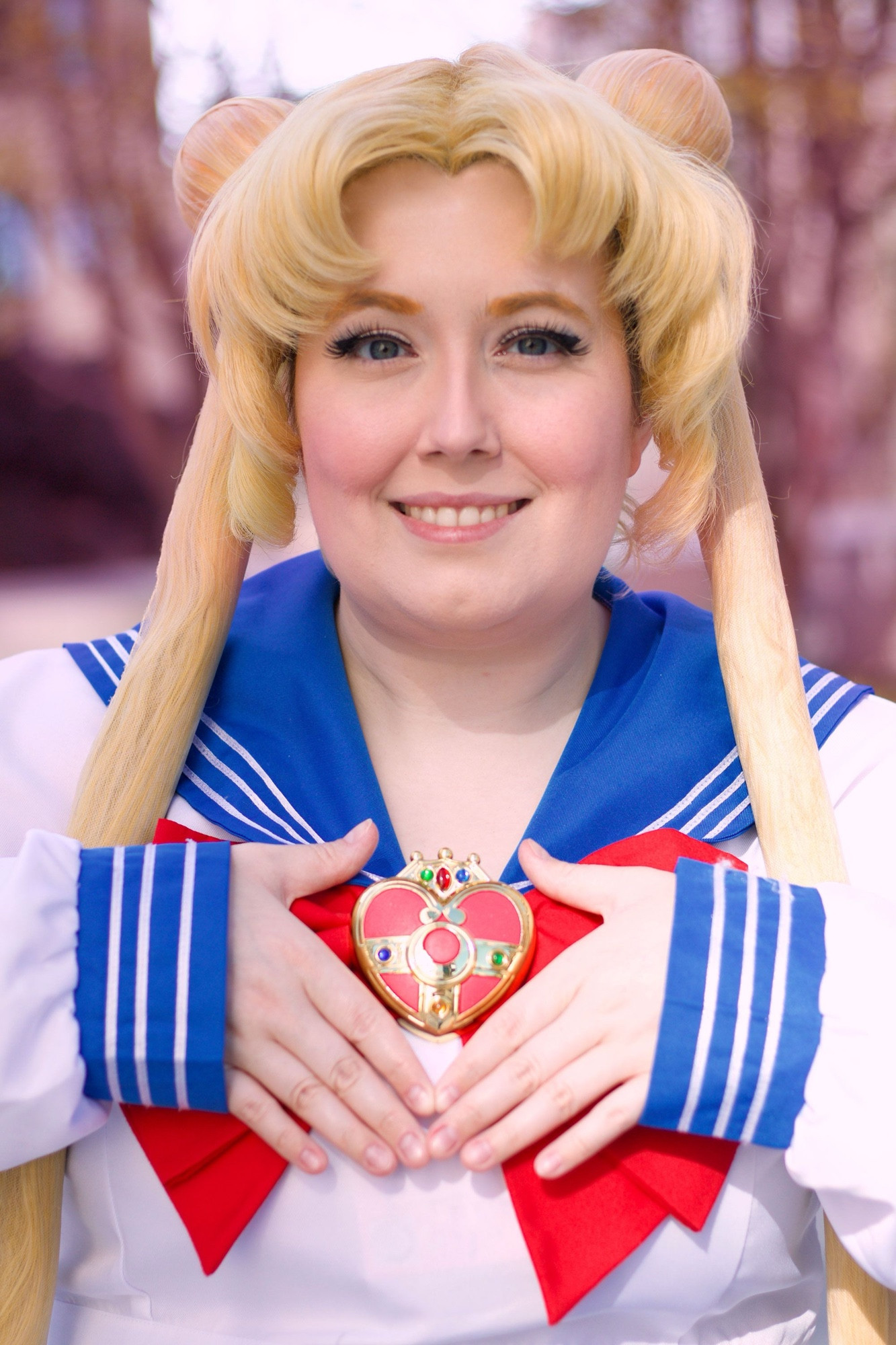 Usagi tsukino cosplay with hands framing the brooch on her chest