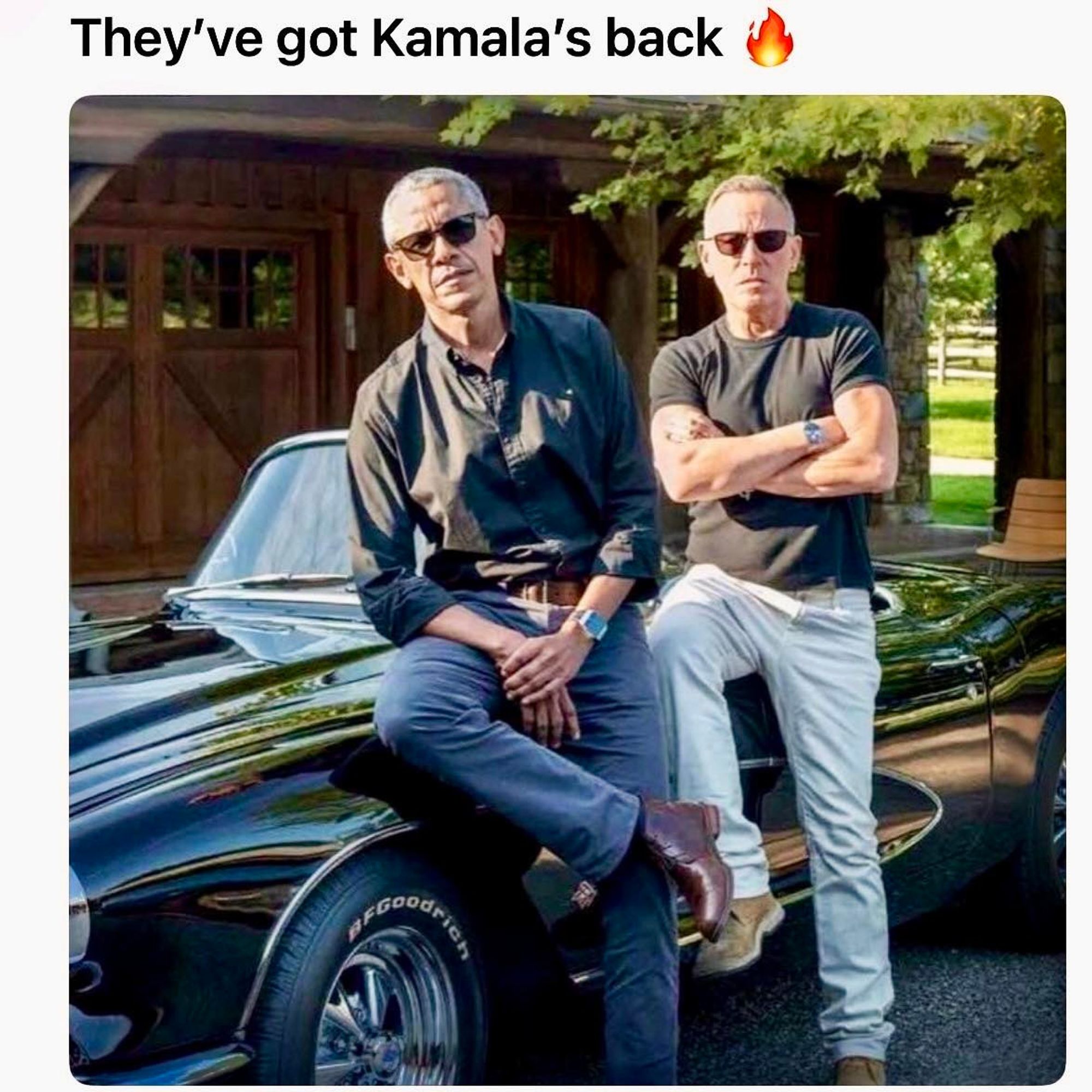 President Barak Obama and Bruce Springsteen leaning against a black Corvette car.