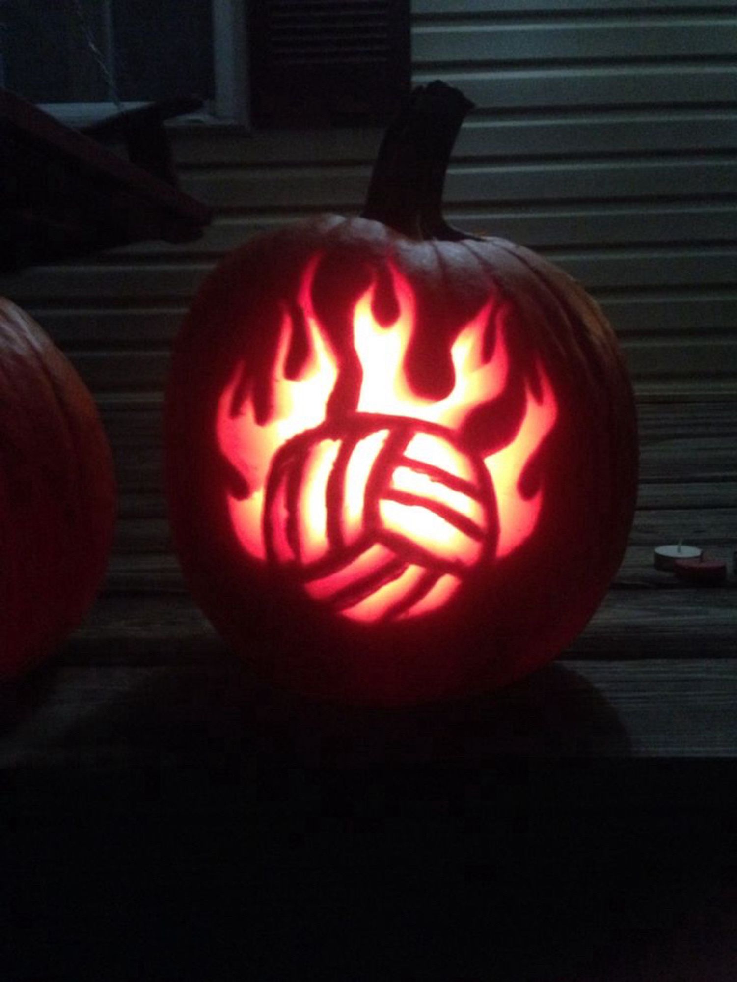 Volley ball with flames carved into jack-o’-lantern