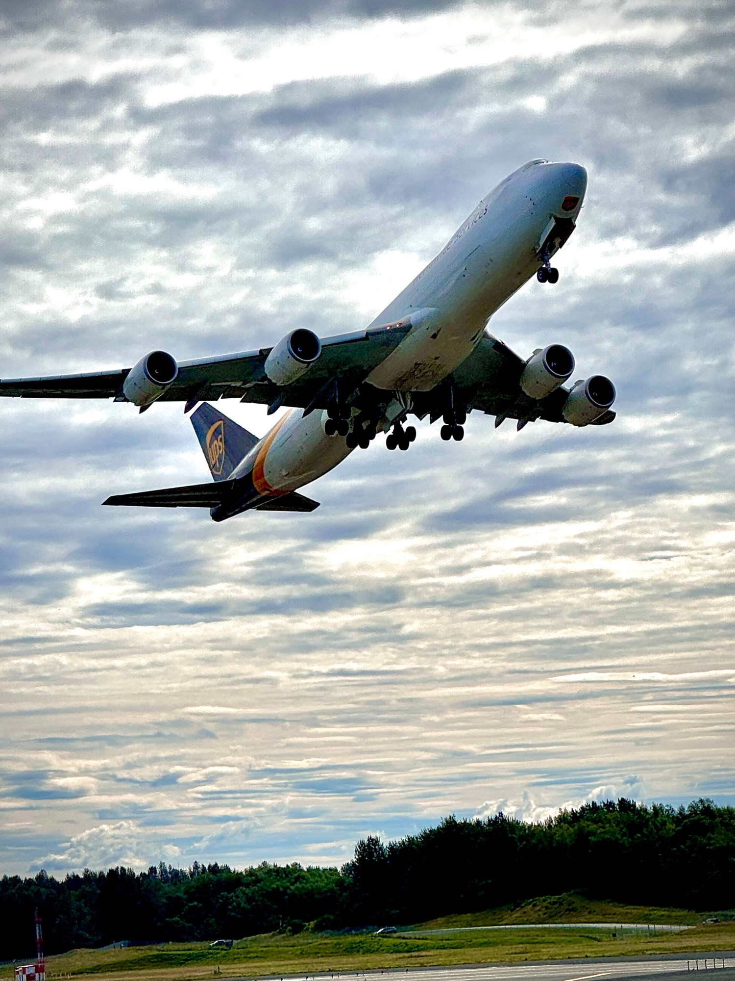 UPS 747-8 freighter taking off Runway 33 at ANC. The gear is just starting to go up.