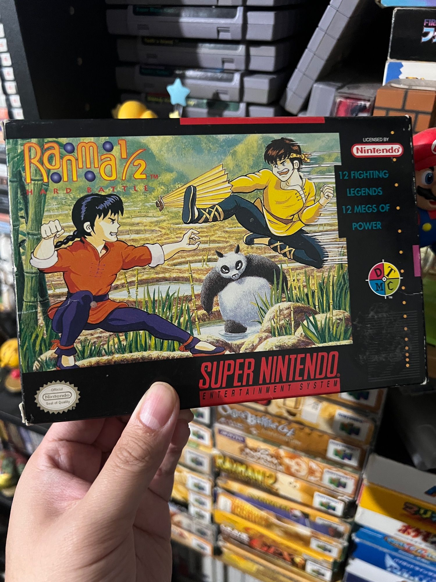 A boxed copy of the North American release of Ranma 1/2: Hard Battle for the SNES. The box declares "12 FIGHTING LEGENDS 12 MEGS OF POWER"