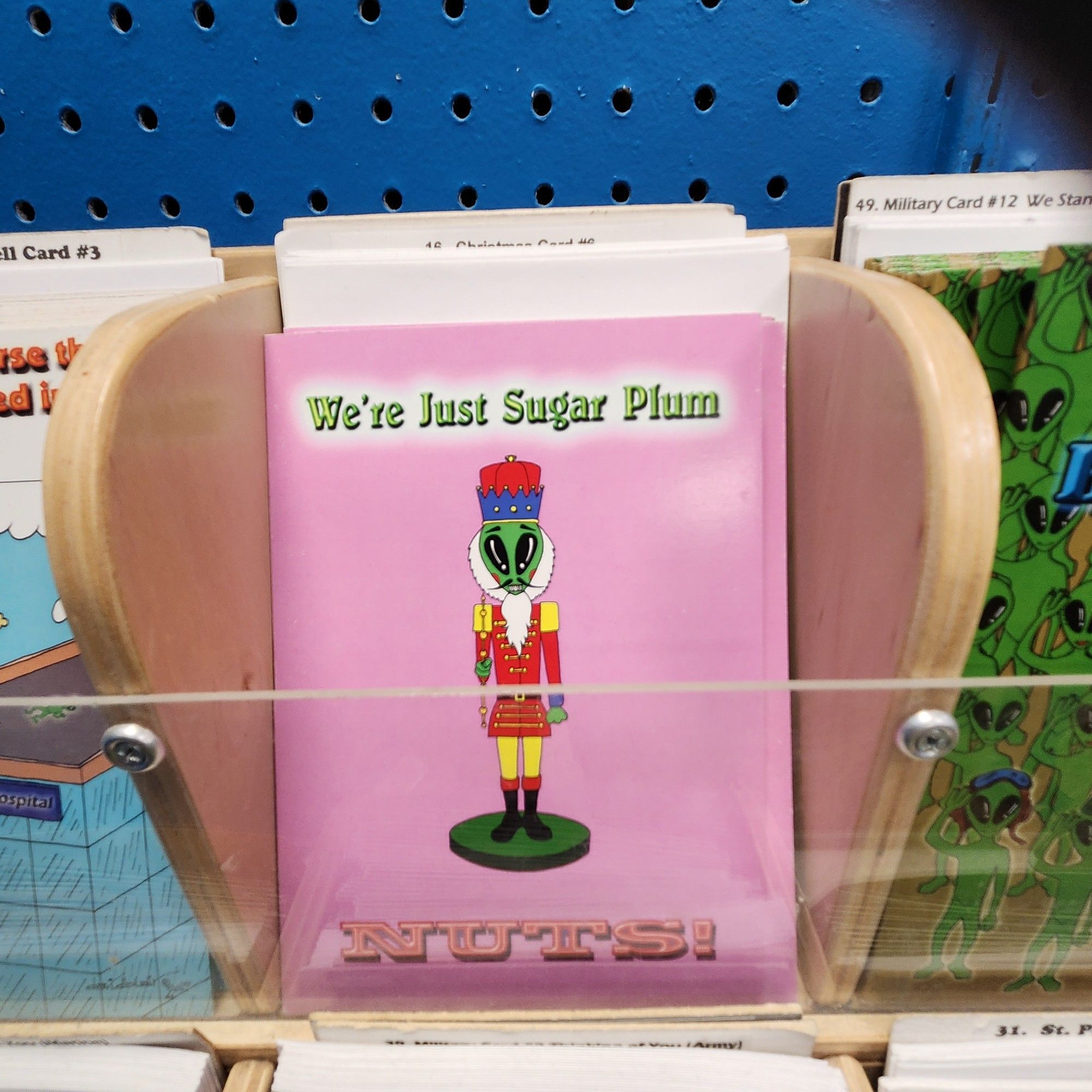 A greeting card with an alien dressed as a Nutcracker. It reads "we're just sugar plum NUTS!"