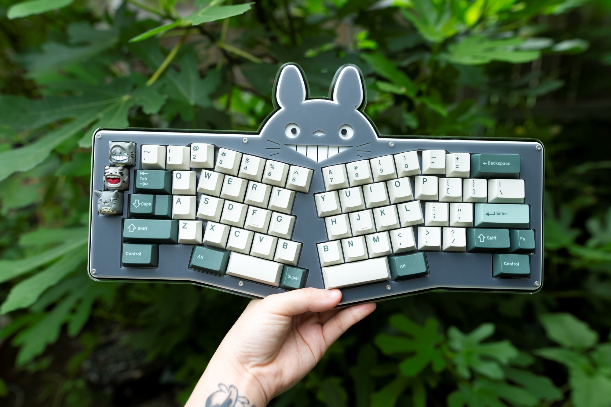 Gray rat, a custom stacked acrylic totoro keyboard that is split (ergonomic) with green and beige keycaps