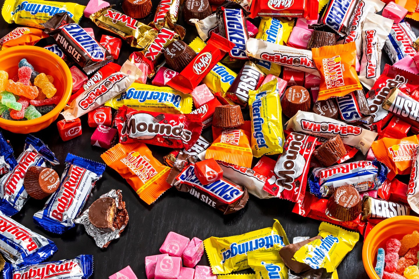 Photo of a pile of an assortment of candies popular for Halloween in the US.