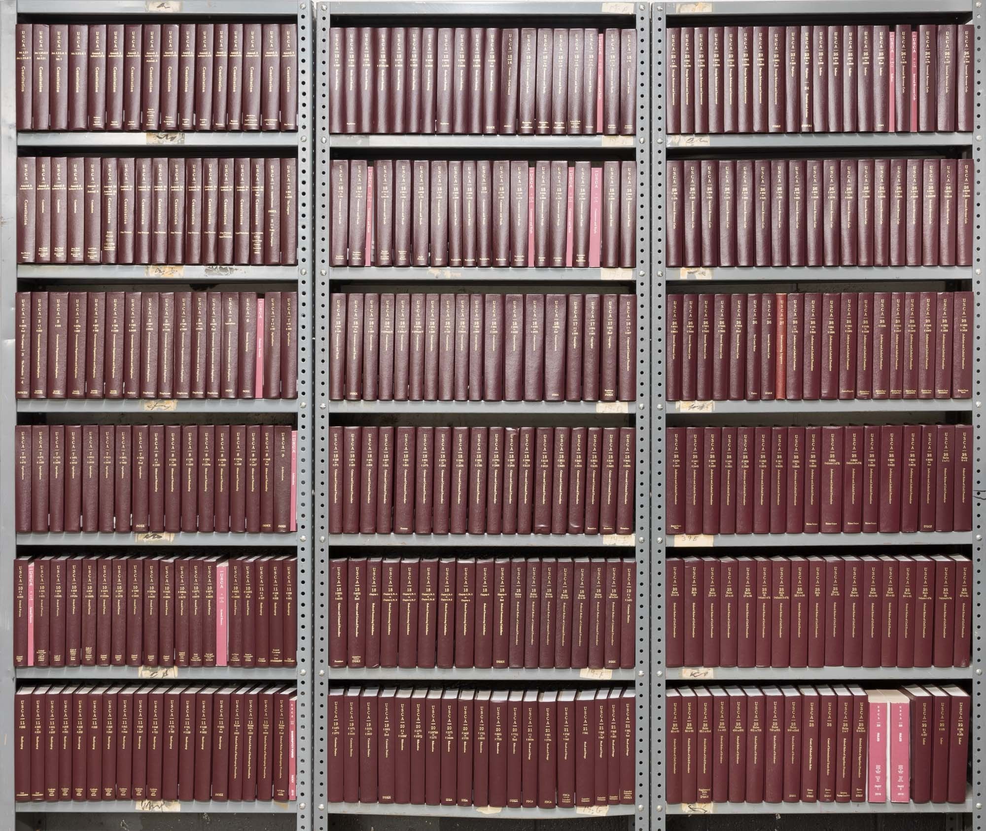 a photograph of the Annotated United States Code, showing that it fills several bookshelves with its volumes