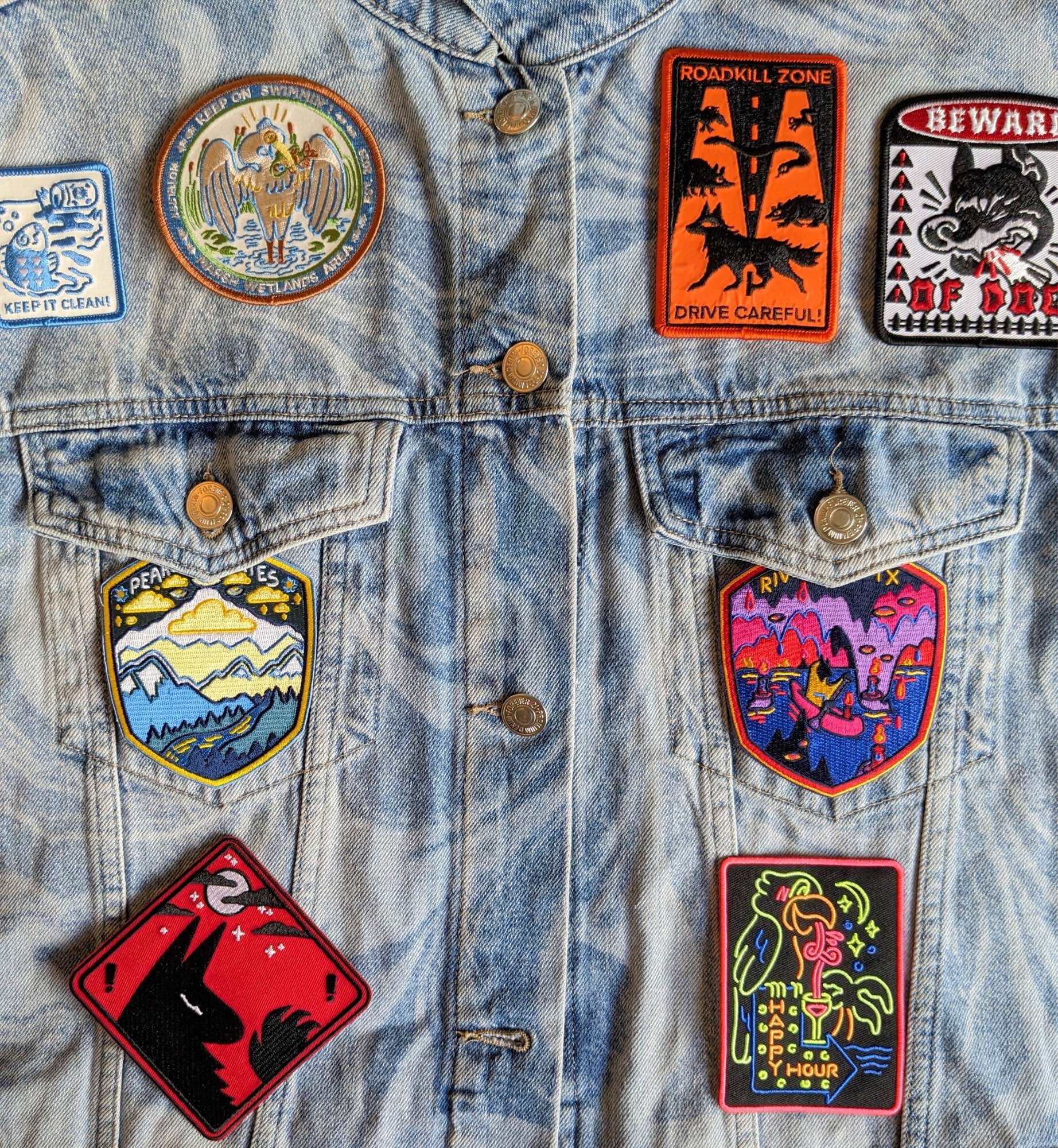 A collection of patches on a jean jacket.