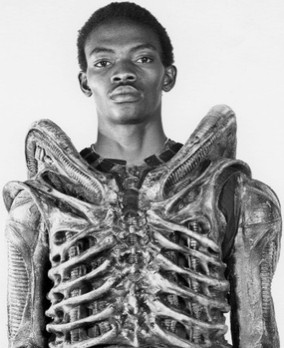 A picture of the actor BOLAJI BADEJO - wearing a xenomorph costume minus the head.