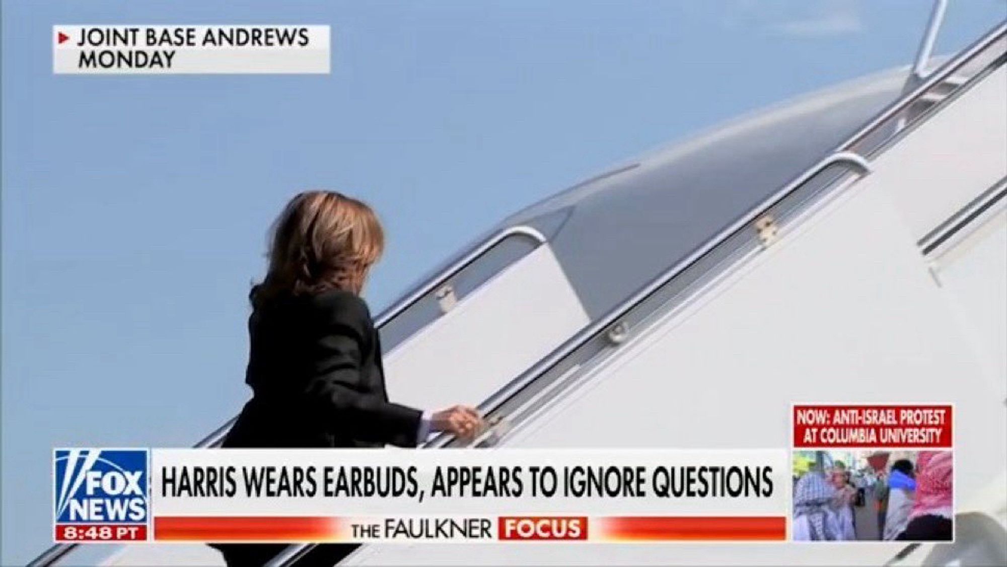 Kamala Harris wears earbuds, appears to ignore questions.