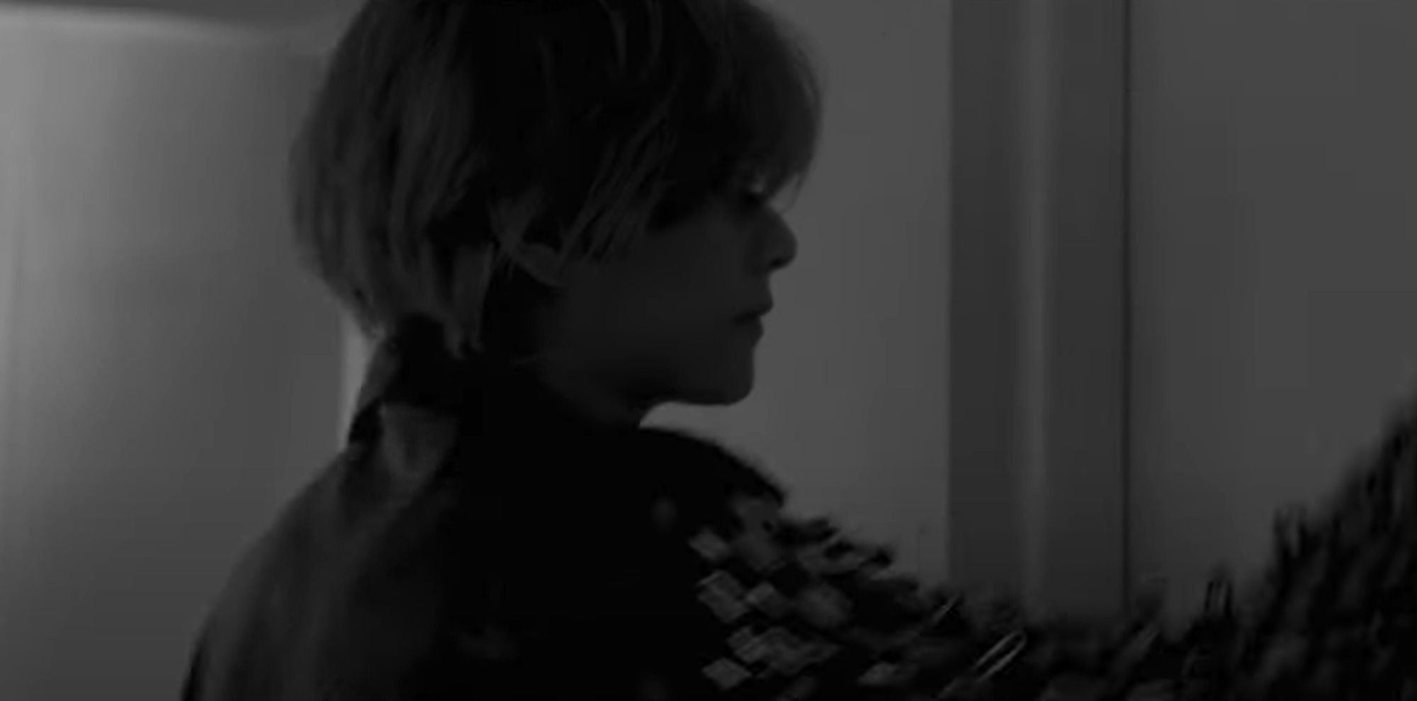 Still from V of BTS' MV teaser for Blue, a single from his upcoming Layover album out 9/13

Black and white, he's in a jacket with safety pins all over the sleeves knocking on a door