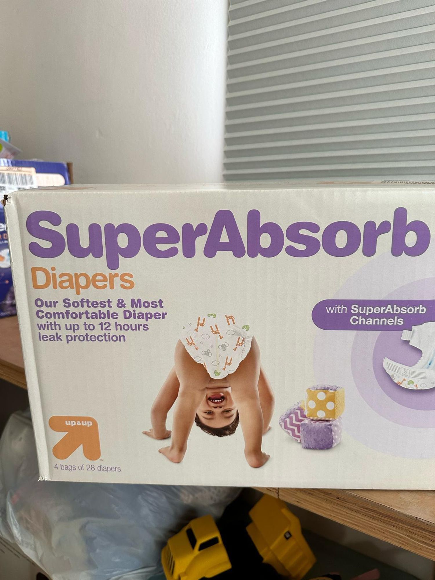 a box of diapers with a baby that looks like pete davidson on it