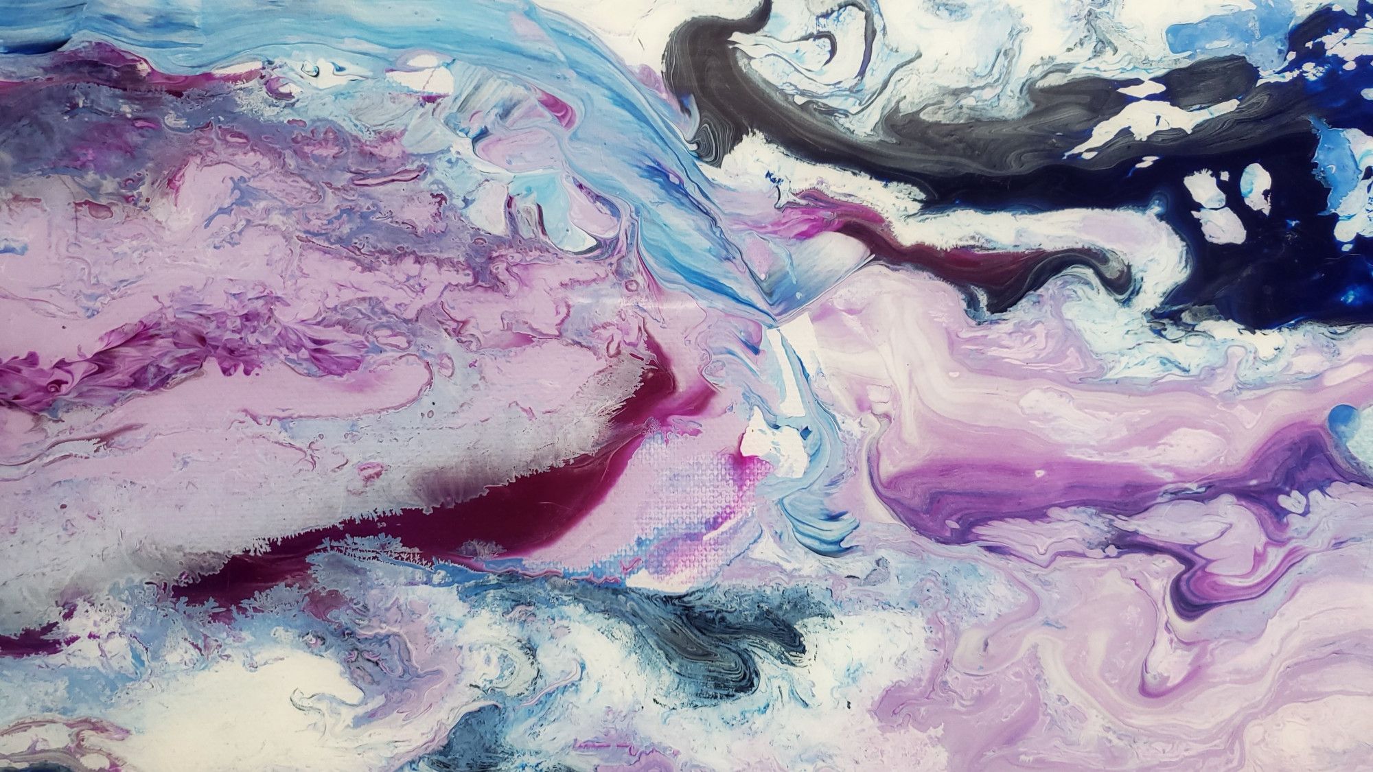 a close-up photo of rock with swirls of purple, blue, and white