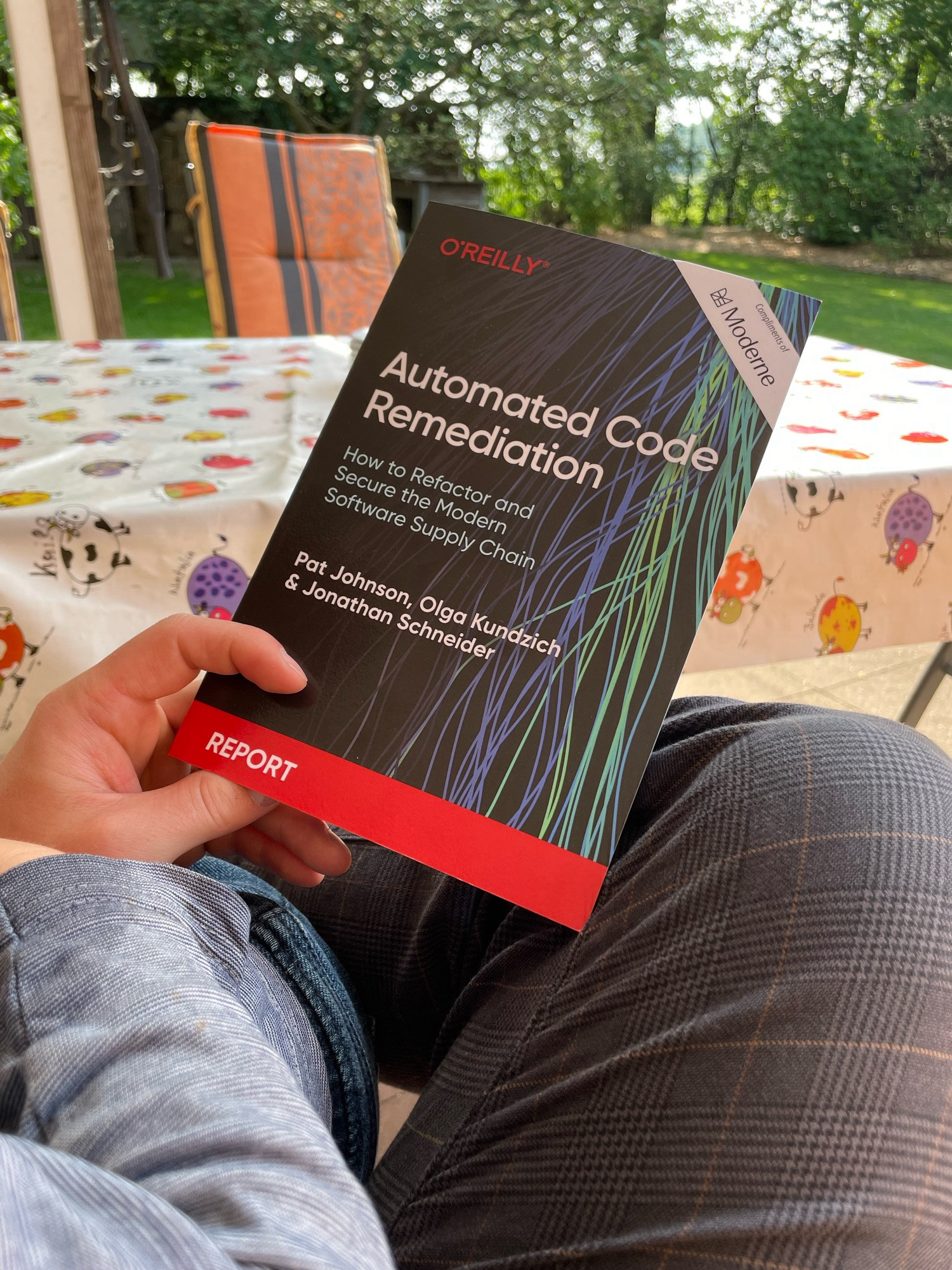 Reading the book Automated Code Remidation by Johnson, Kundzich and Schneider in the garden