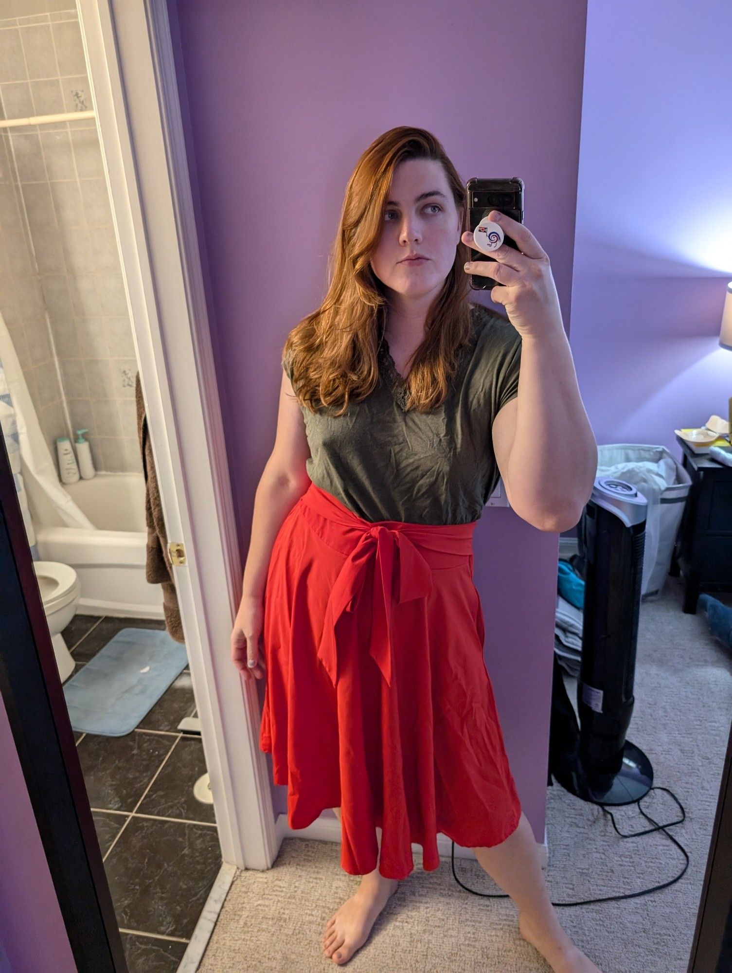 Emily with a green top and a long red skirt