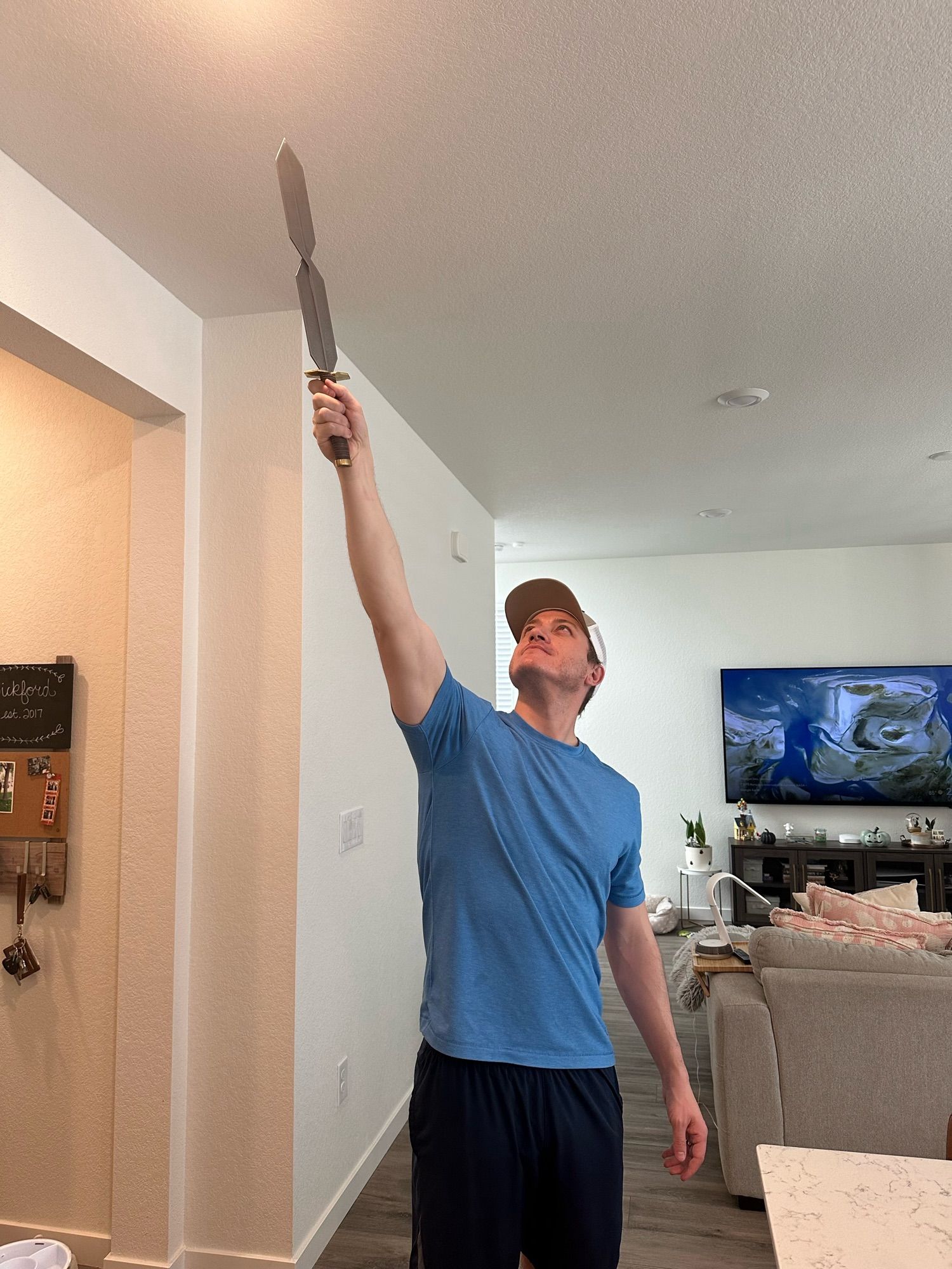 Me reaching the cool s sword toward the light. The light of my ceiling.