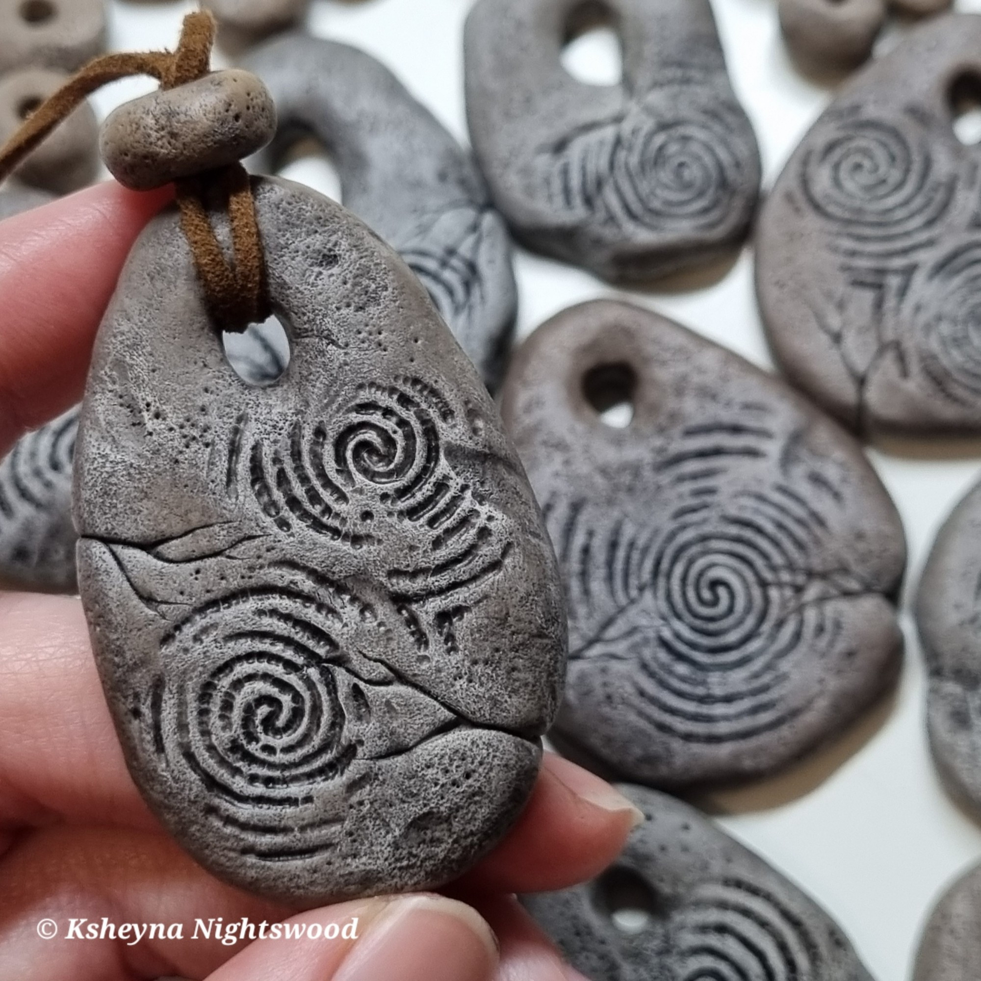 Sculpted (Scandinavian-inspired) troll pendant, painted to look like stone with carved spirals.