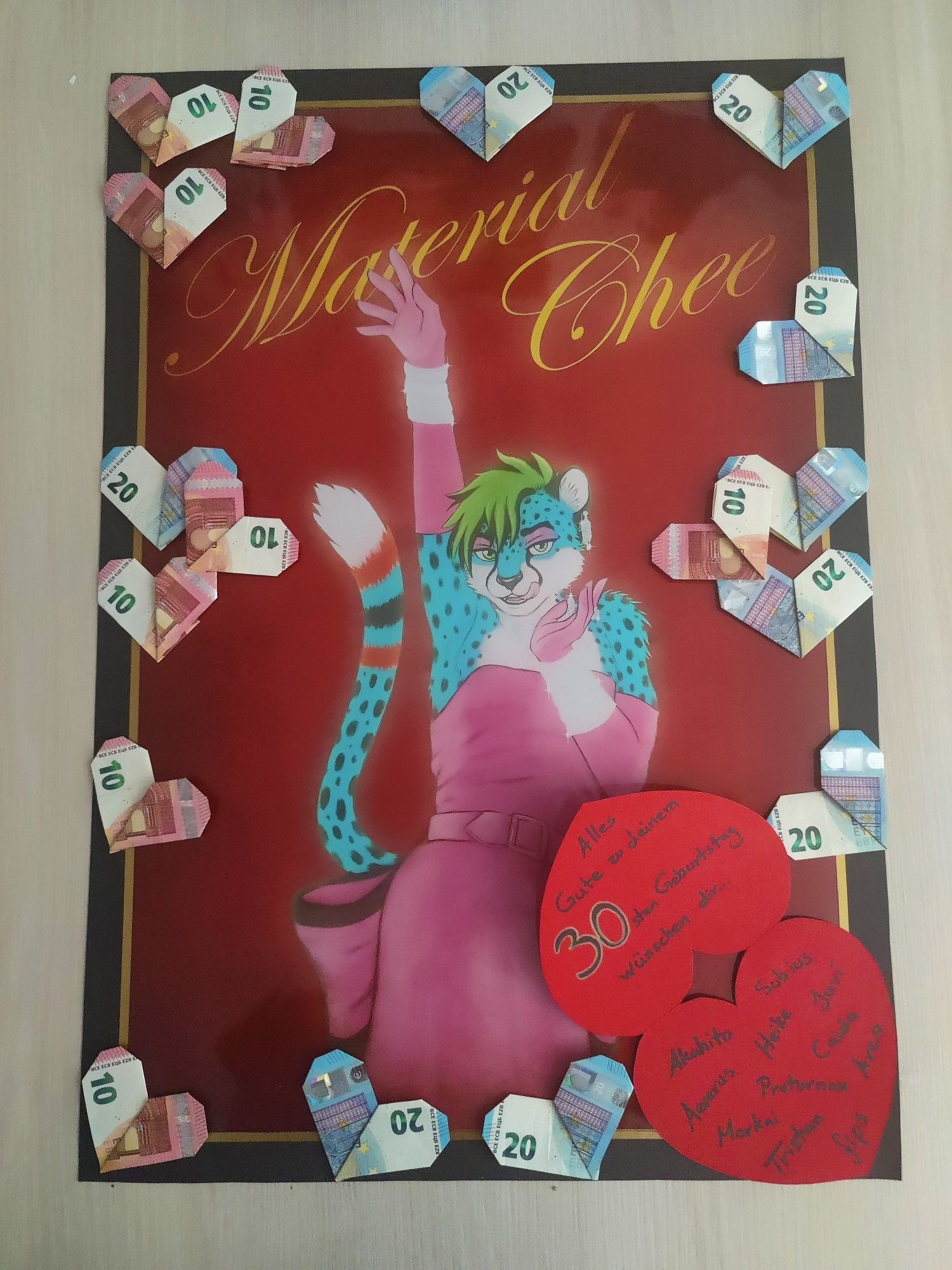 Photo of the printed poster I made, with money hearts taped on and the heart shaped card opened