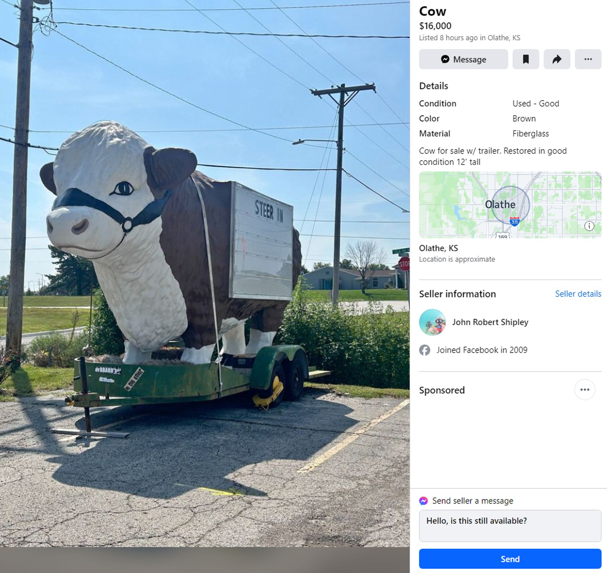 A Facebook marketplace ad for Cow $16,000 in Olathe, KS. It's is a brown and white cartoonish cow on a green trailer with building with built-in marquee signs on the sides. It currently reads "STEER IN." There is a yellow "boot" tire locking device on it.