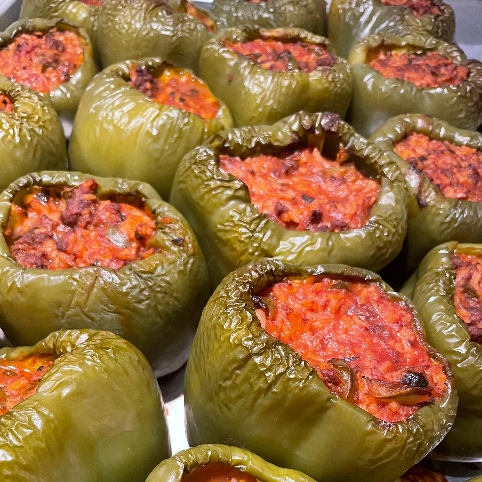 a tray of stuffed green peppers 