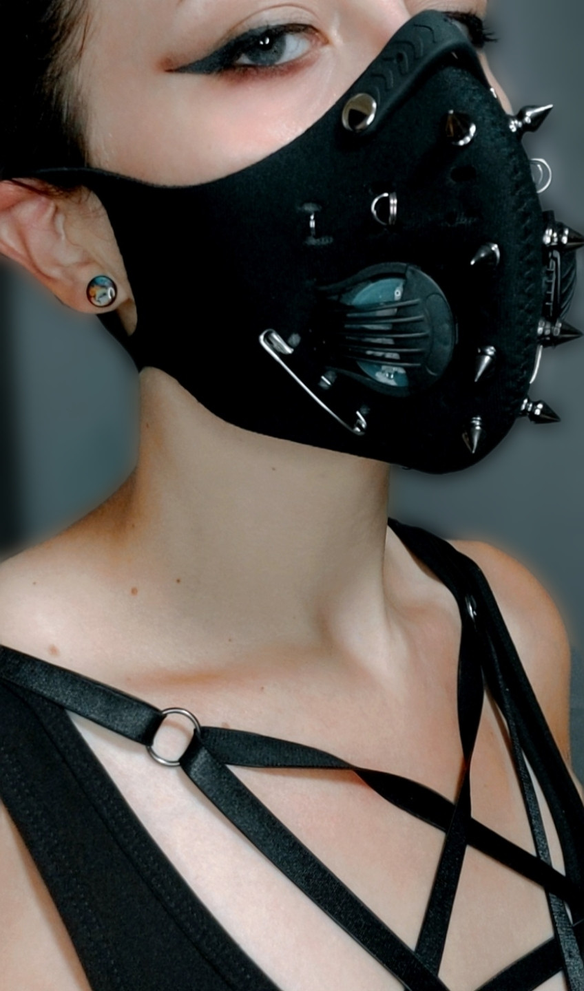 Photo of me wearing a mask with my neck as the main focus. I am looking into the camera, but the tip of my head is out of frame.