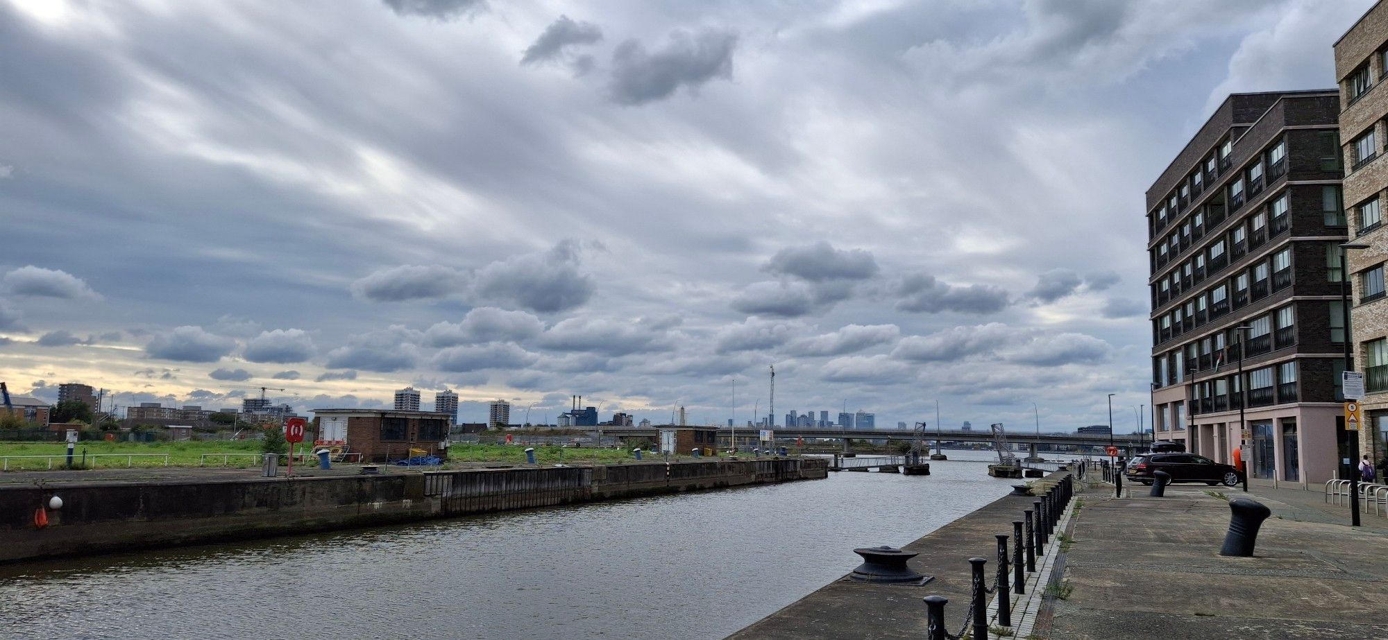 The redevelopment of Royal Albert Wharf. There are the broken deserted huts on one side, new flats on the other and the looming of The City at the back. F me it makes Thamesmead look like a Bohemian retreat