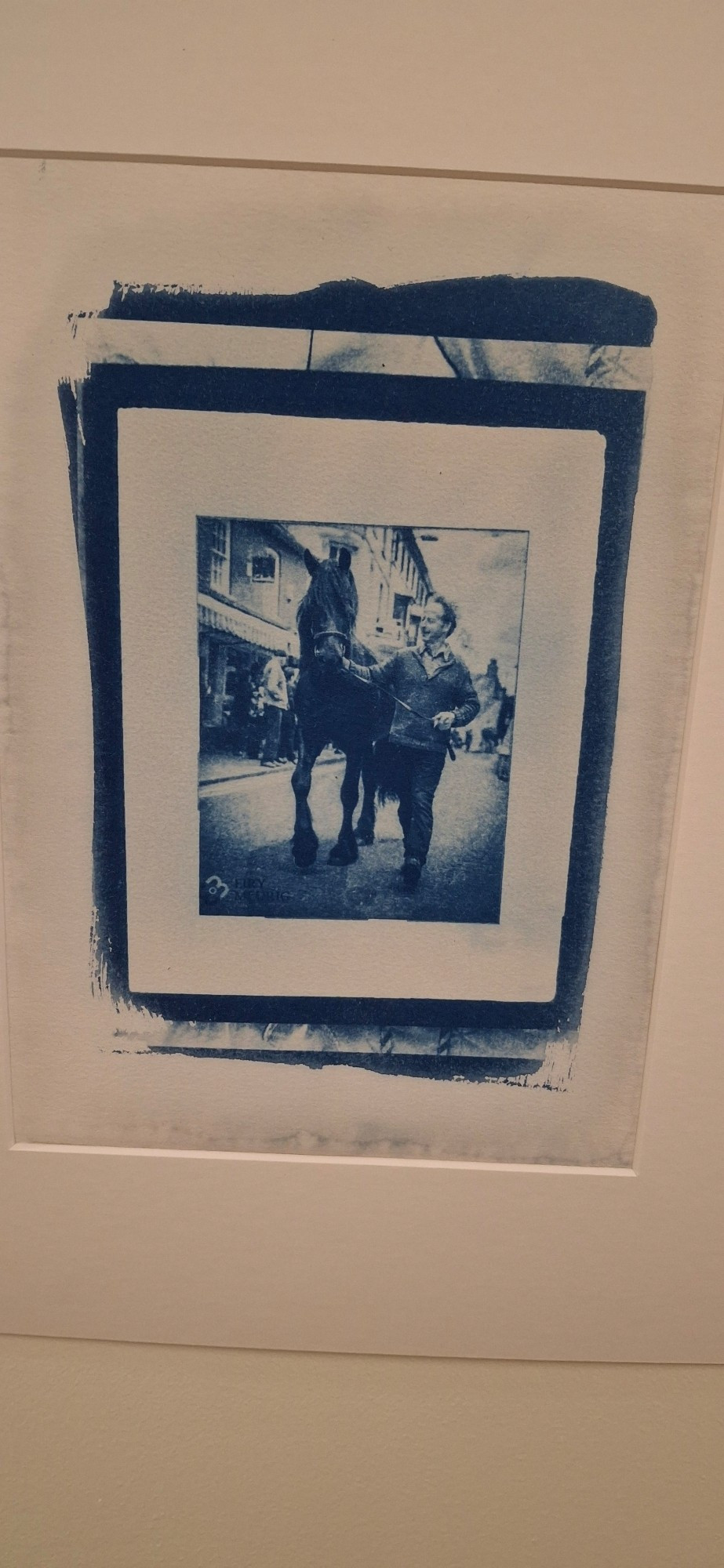 Two blue tone prints. One of a man with a horse and the other jewellery. Plas Cwmcynfelin care home in Ceredigion, Wales. Residents and their carers have collaborated to create photographic sun prints (cyanotypes) of objects from their lives. These are items they own and treasure, which may seem ordinary or insignificant to others. Artist Alice Briggs encouraged the pairs to exchange memories about their objects, focusing on themes of family, identity, and a sense of belonging.