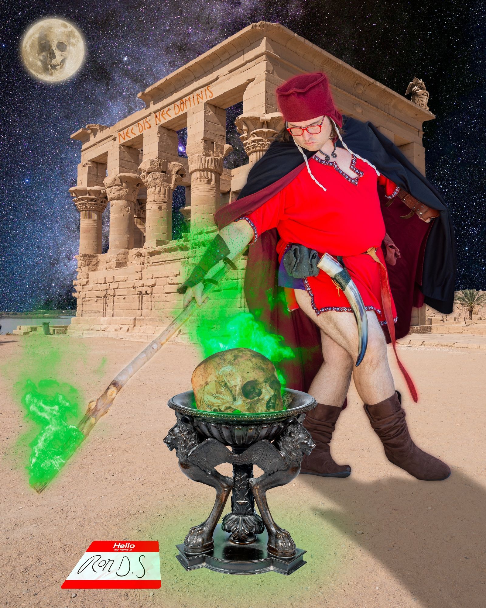 A red wizard circles a bazier, alight like his staff with green flame. In it burns a skull. Behind him, a rotting temple, with a bored gargoyle & the phrase "NEC DIS NEC DOMINIS" emblazoned in red across its top, where a bored gargoyle also sits. On the ground in the glowing light of the brazier is a nametag that reads "Ron D. S." 