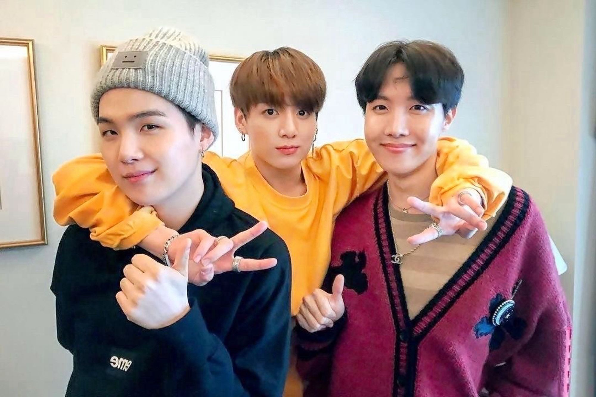 Jungkook has his arms hooked around Suga and j-hope’s necks and he’s making peace signs while sope are giving thumbs up