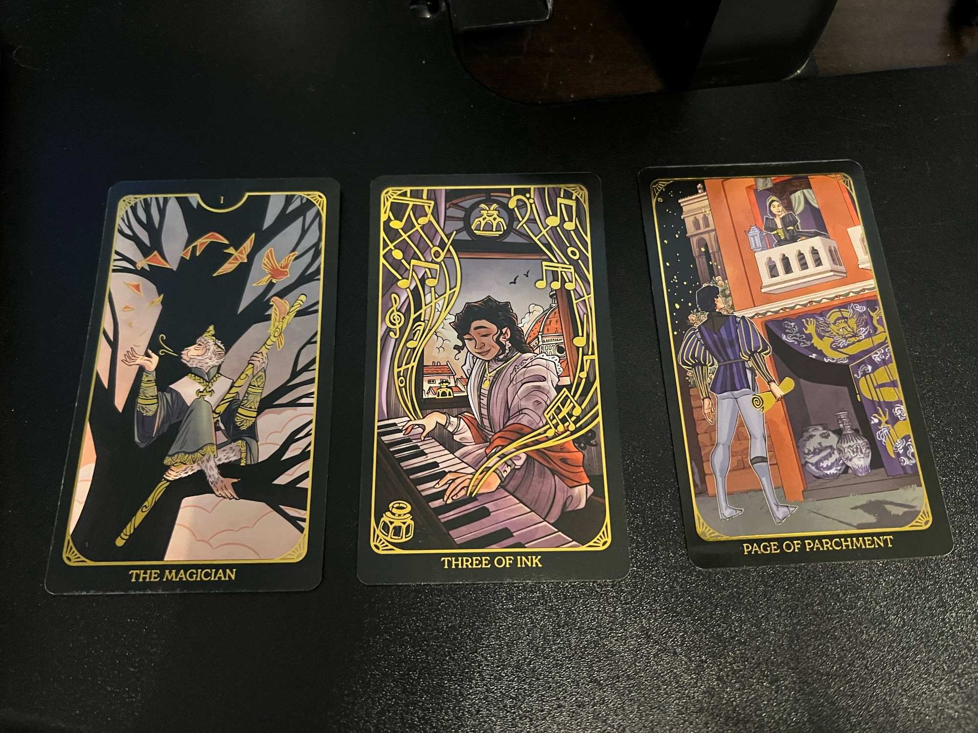 Three tarot cards next to each other: the magician (magical monkey in a tree), three of ink (woman playing piano), and page of parchment (Romeo and Juliet)