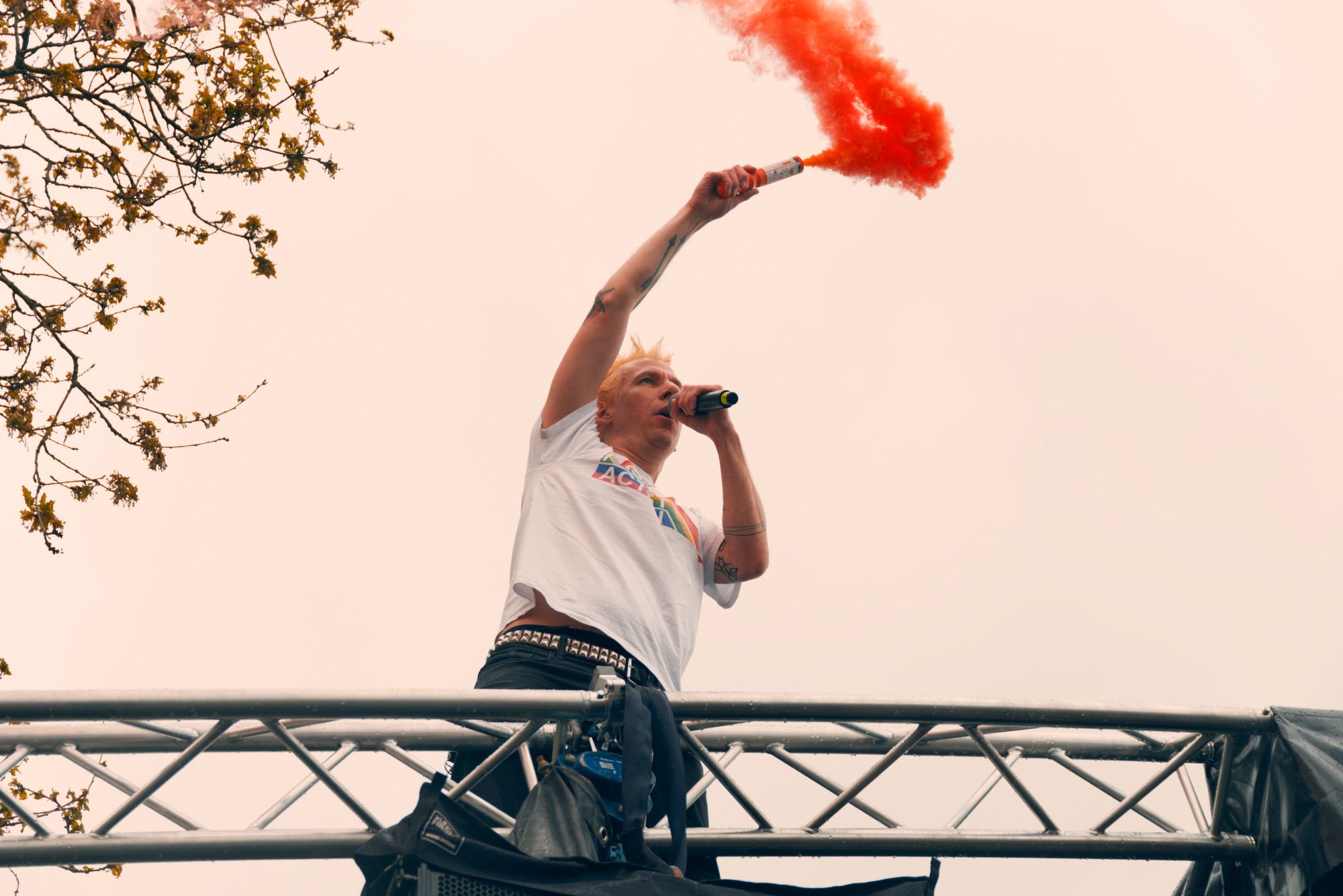 Joshi von ZSK mit einem orangen Rauchtopf in der Hand auf dem Dach der Bühne