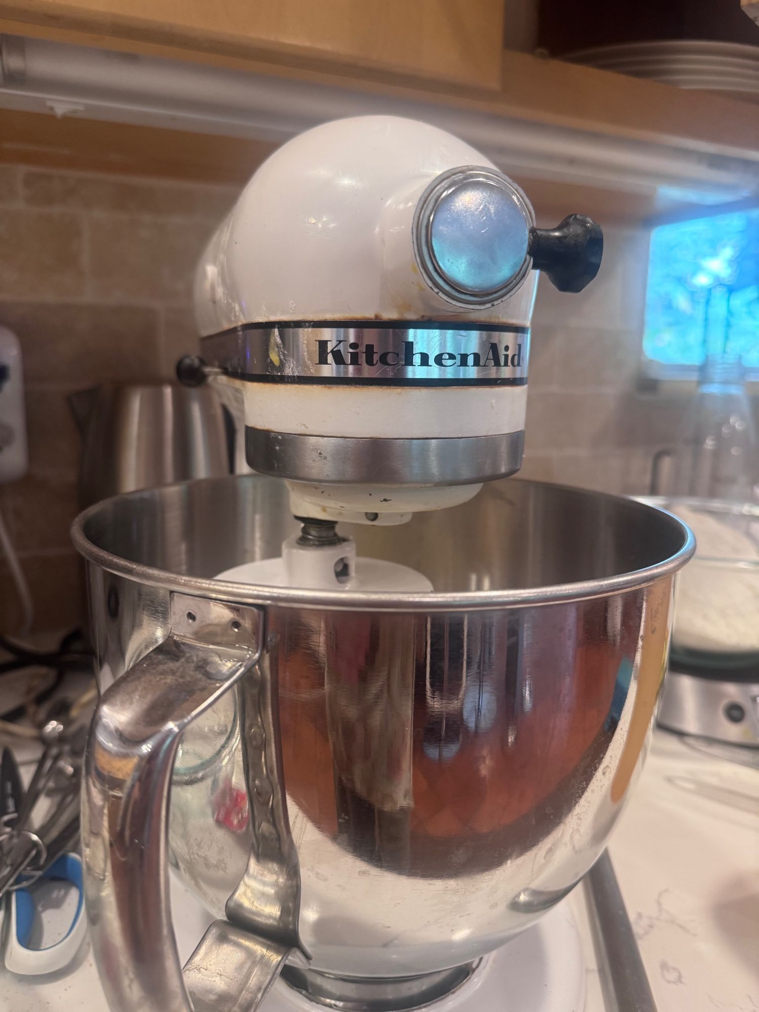 An old stained KitchenAid stand mixer on the counter