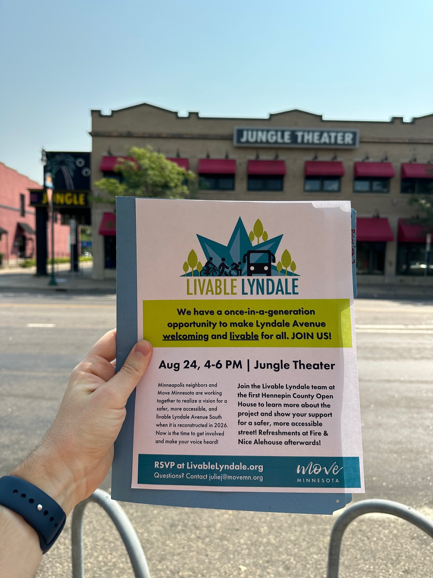 Brian holing a flyer with Jungle Theater in the background. The flyer says:

LIVABLE LYNDALE
We have a once-in-a-generation opportunity to make Lyndale Avenue welcoming and livable for all. JOIN US!
Aug 24, 4-6 PM | Jungle Theater
Minneapolis neighbors and Move Minnesota are working together to realize a vision for a safer, more accessible, and livable Lyndale Avenue South when it is reconstructed in 2026.
Now is the time to get involved and make your voice heard!
Join the Livable Lyndale team at the first Hennepin County Open House to learn more about the project and show your support for a safer, more accessible street! Refreshments at Fire & Nice Alehouse afterwards!
RSVP at LivableLyndale.org
Questions? Contact juliej@movemn.org