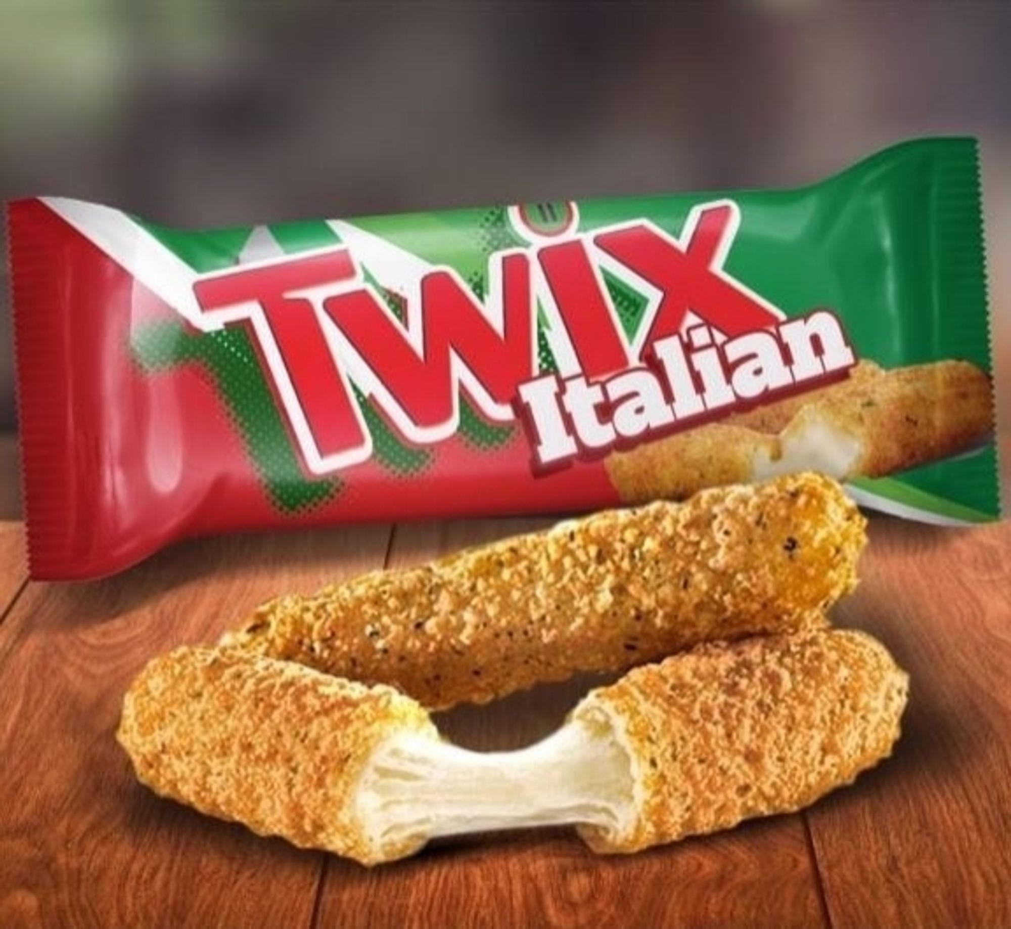 Two mozzarella sticks out on a table and one has been split open so you can see the runny cheese, and behind a package that says Twix Italian and it's red and green