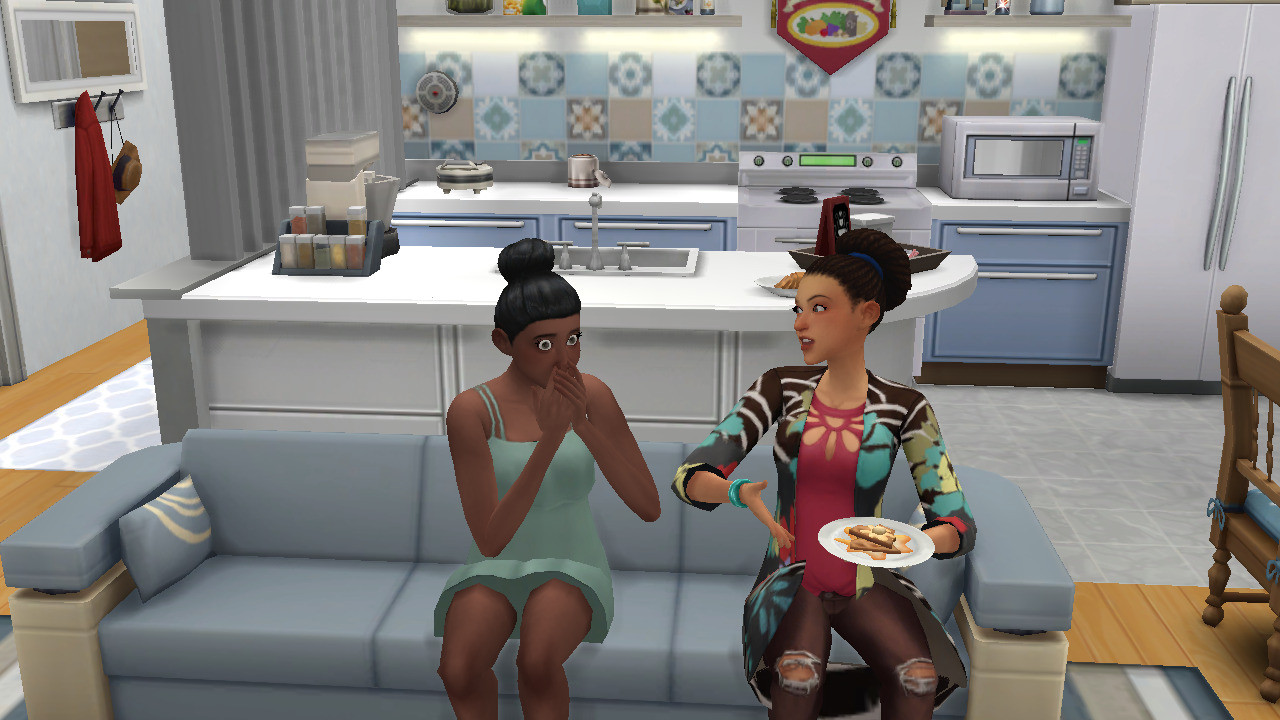 Jesminder & Blake talk while sitting on the couch. Jesminder is holding a a plate of waffles, and Blake covers her mouth while looking shocked.