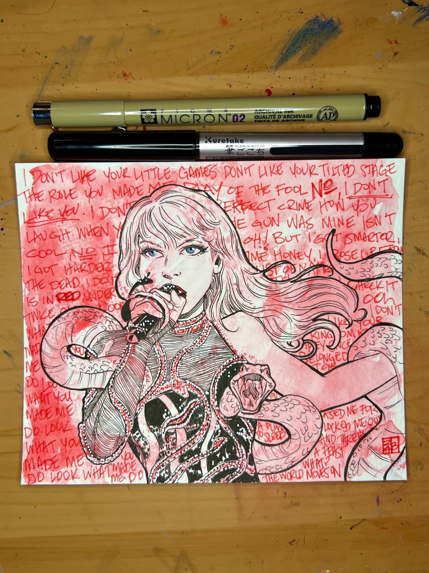 Taylor Swift sketch of her wrapped in a snake while singing Look What You Made Me Do