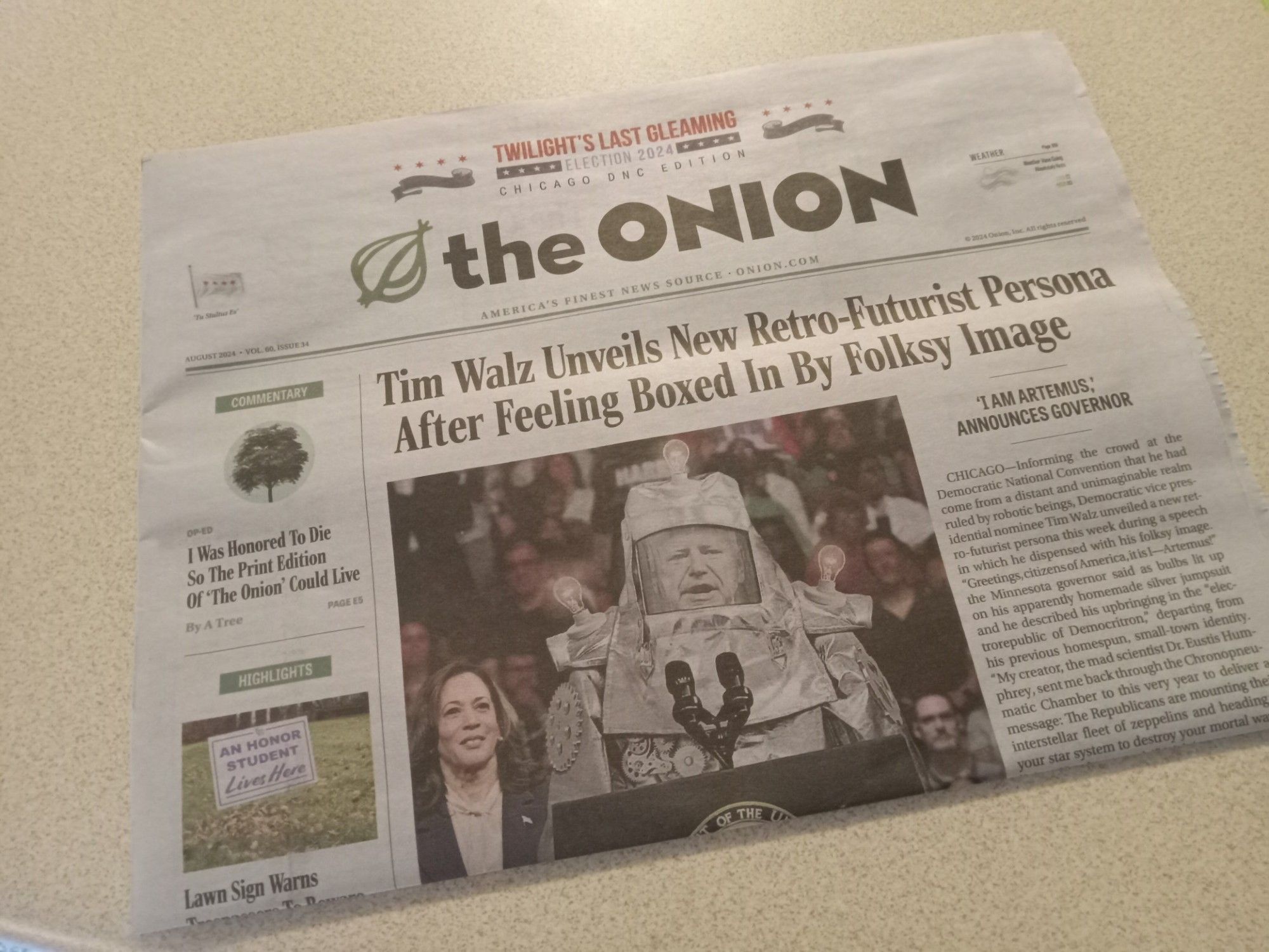 front page of the satirical newspaper "the onion" featuring an article about tim walz wearing a robot costume and calling himself artimus.