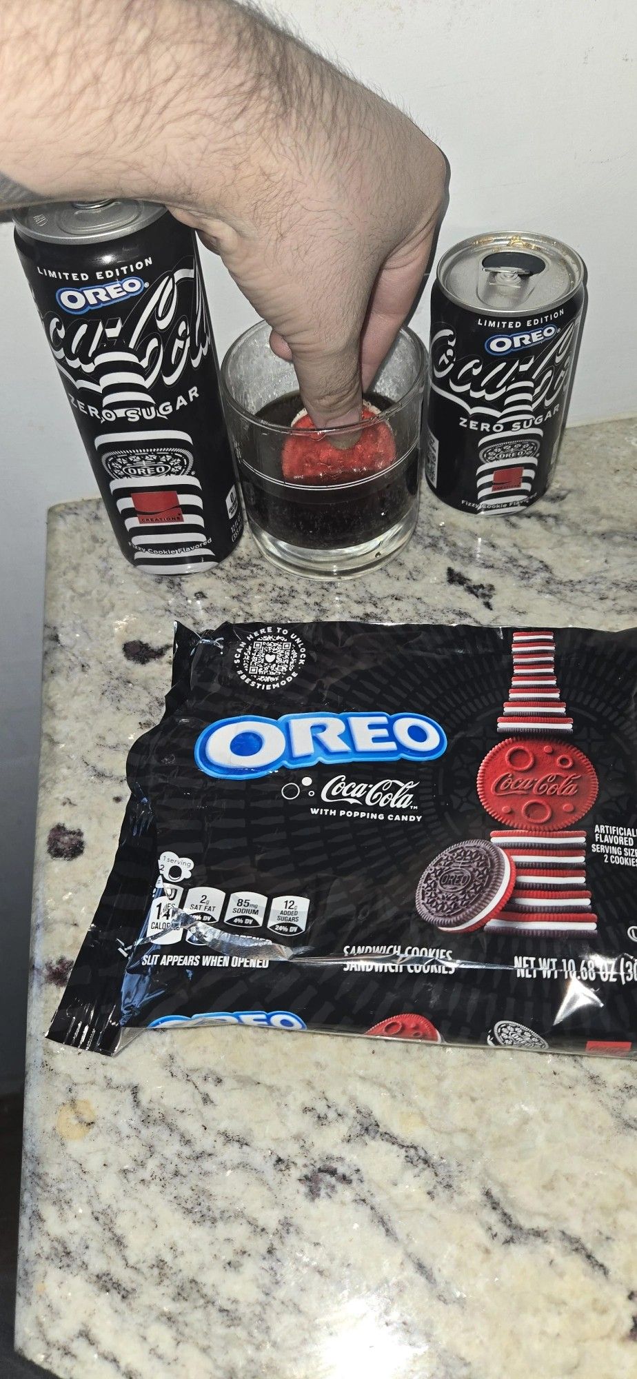 Ht to u/Smoking420 for this photo of a Coca-Cola-flavored Oreo (with popping candy) being dipped into an Oreo-flavored Zero Sugar Coke. :( The black packaging with red and white accents are displayed with the godless abomination.