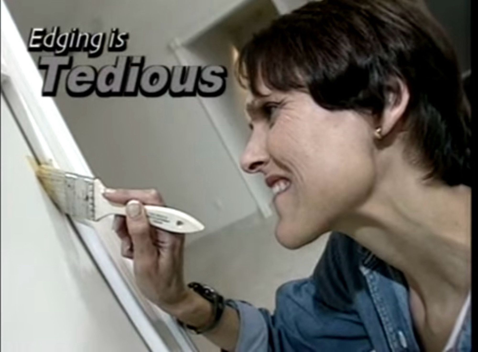 A woman with a paint brush straining to paint next to a door frame with text above her "edging is tedious"