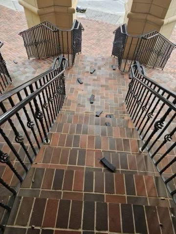 Magazines and shell casings resting on the steps of outdoor staircase 