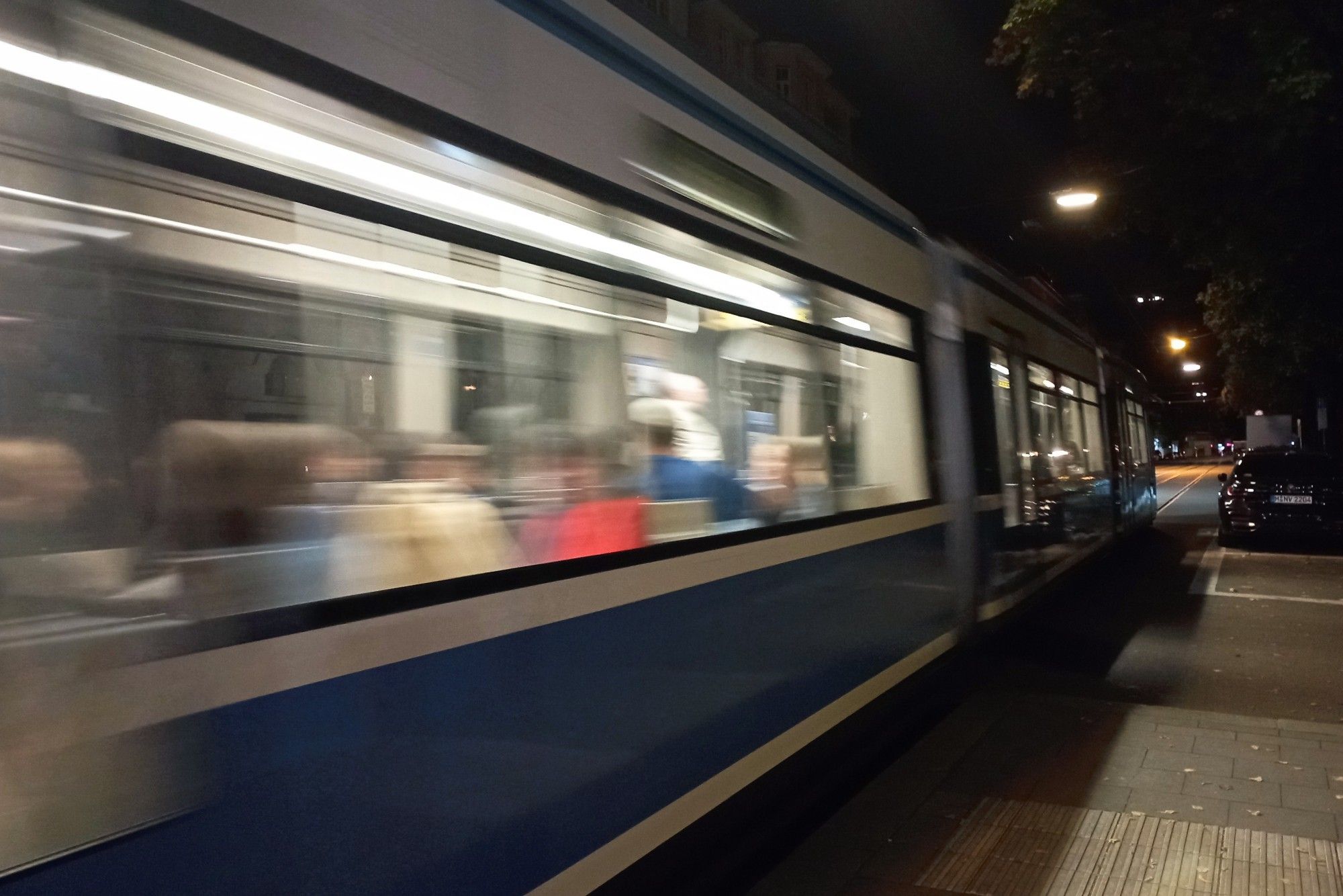 Tram-H Hohenzollernplatz Richtung Nordbad. Im Dunklen fährt eine Tram vom Typ R2a ab.