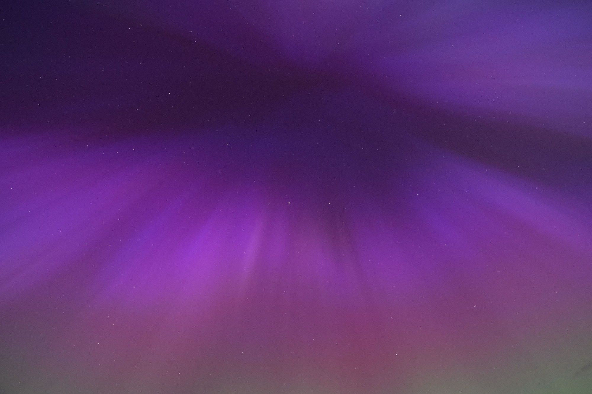 Purple aurora radiating from a central point.