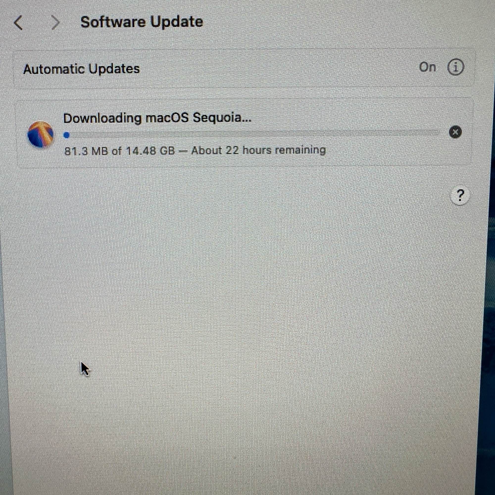 Picture showing a system downloading macOS Sequoia. The bar says “81.3 MB of 14.48 GB - About 22 hours remaining”